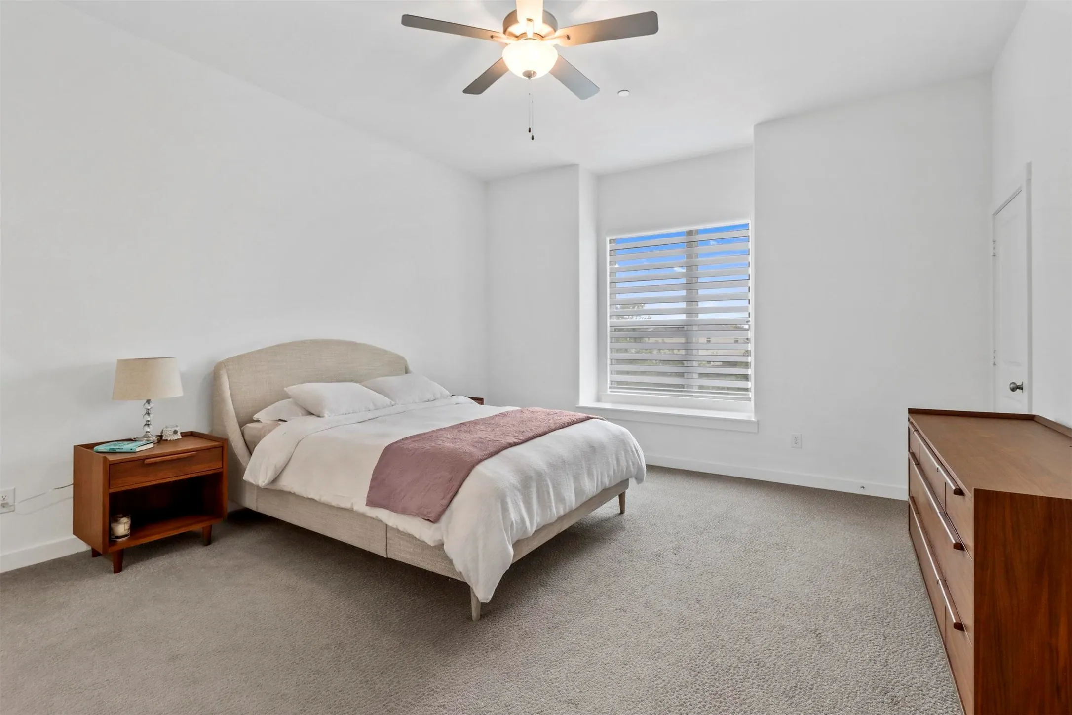 Primary bedroom with a spacious walk-in closet and high ceilings.### Tips for effective listing photo descriptions:
*   **Focus on Key Selling Points:** Mention high-value features like vaulted ceilings, crown molding, or custom built-ins to draw interest.
*   **Highlight Functionality:** Emphasize the storage potential of the walk-in closet, as this is a top priority for potential buyers.
*   **Keep it Concise:** Use clear, descriptive language that complements the visual appeal of the photo without being overly repetitive.
*   **Maintain Consistency:** Use a similar tone and structure for all your photo descriptions to keep your listing professional and easy to read.