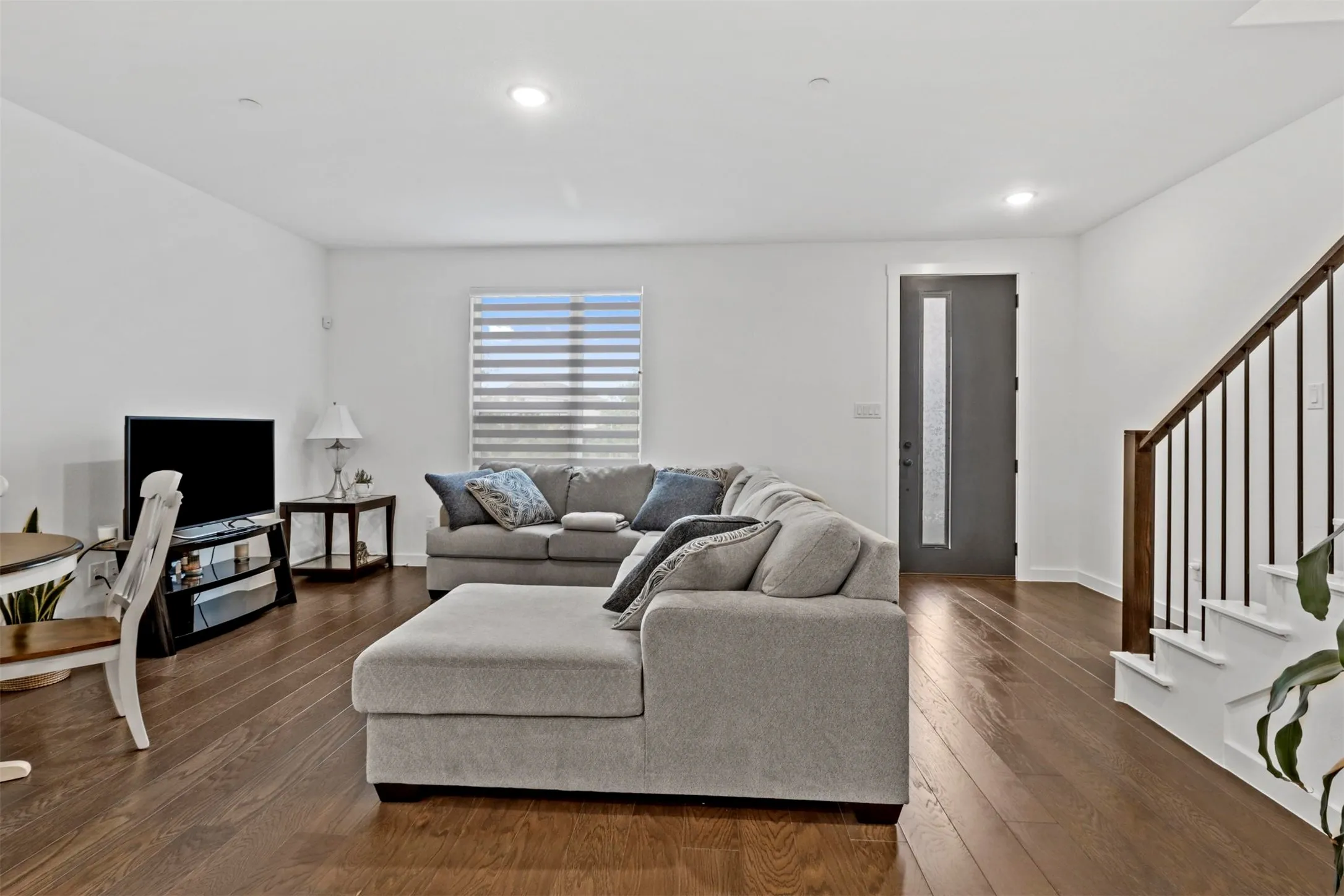 Open concept living space featuring wide wood flooring