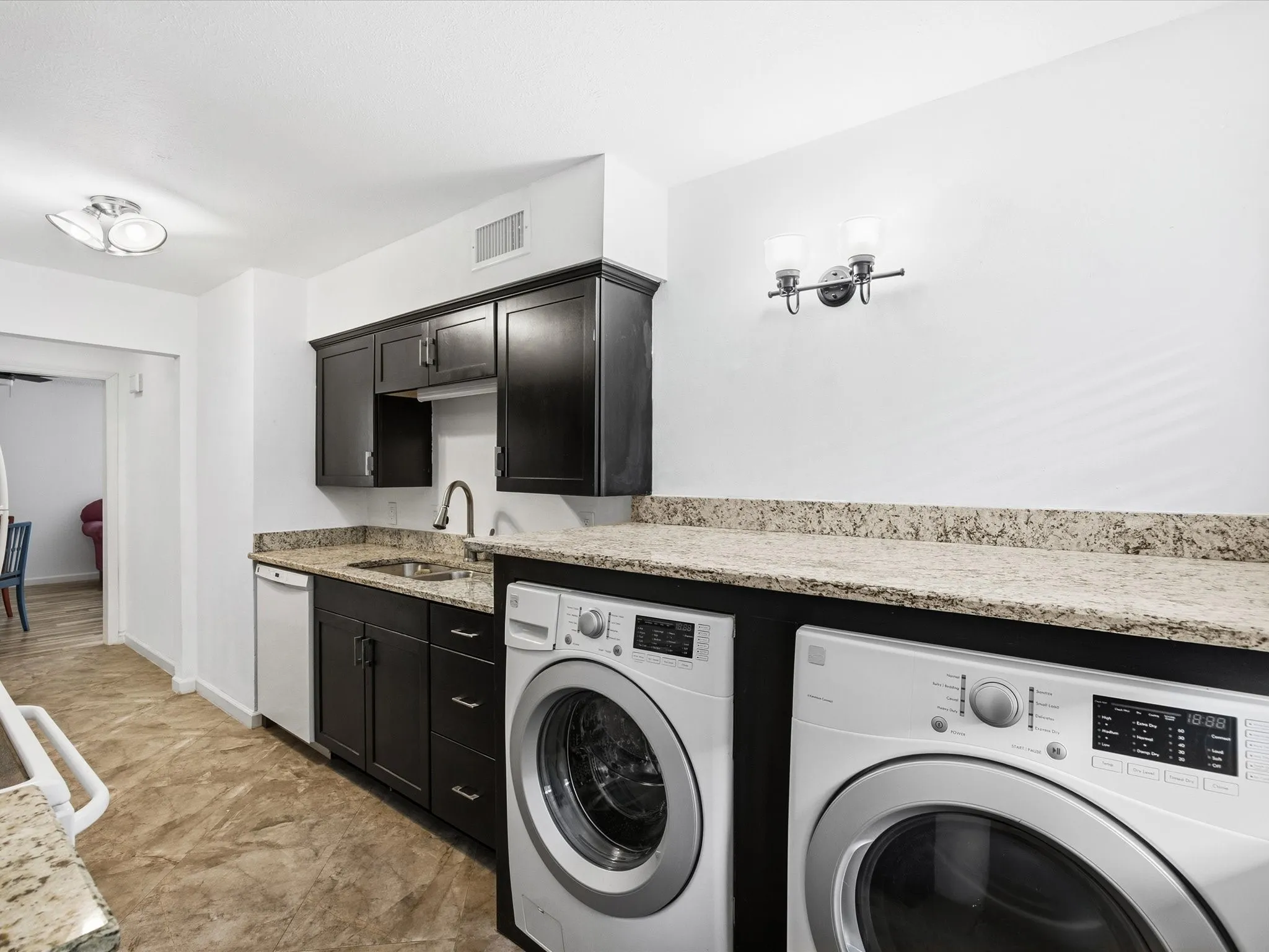 Laundry room with baseboards and washer and clothes dryer