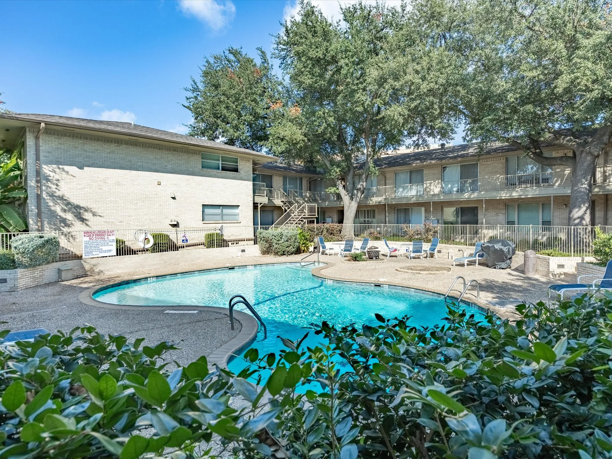 Community pool with a patio and stairs