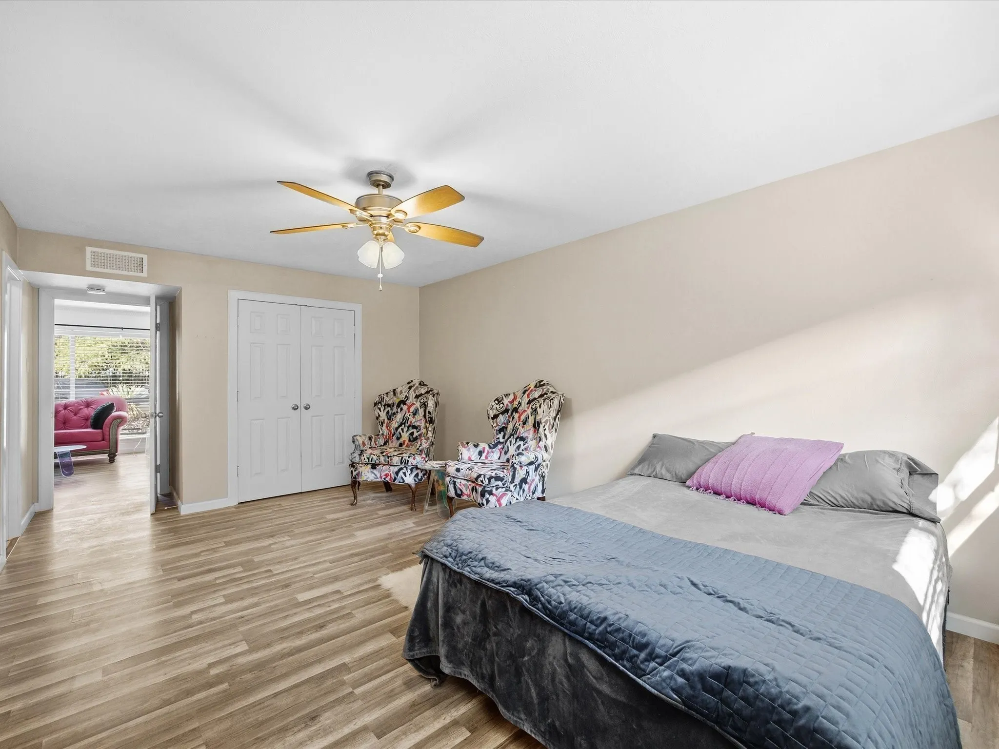 Primary Bedroom featuring wood finished floors, a ceiling fan, and a closet