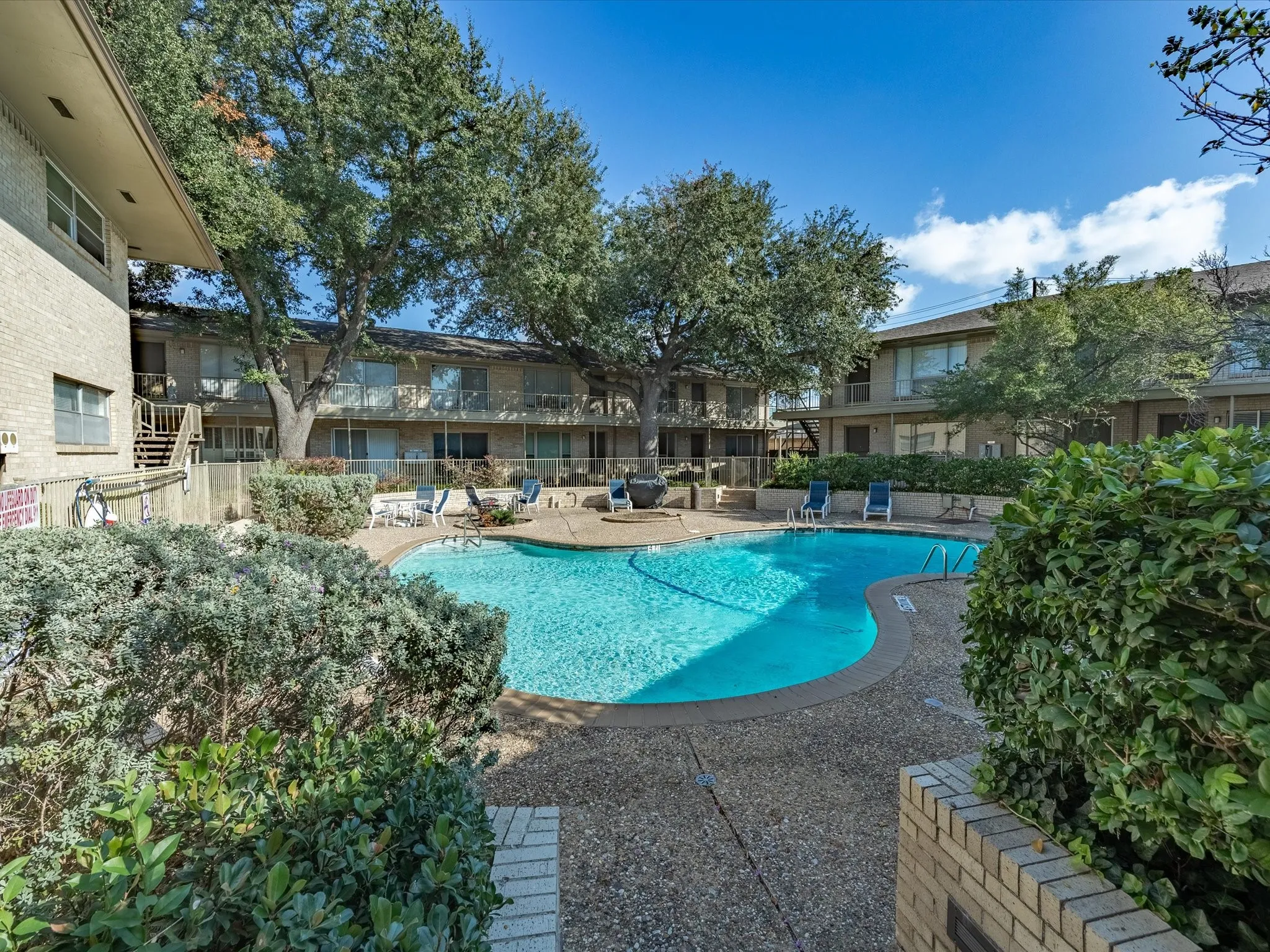 Community pool with a patio