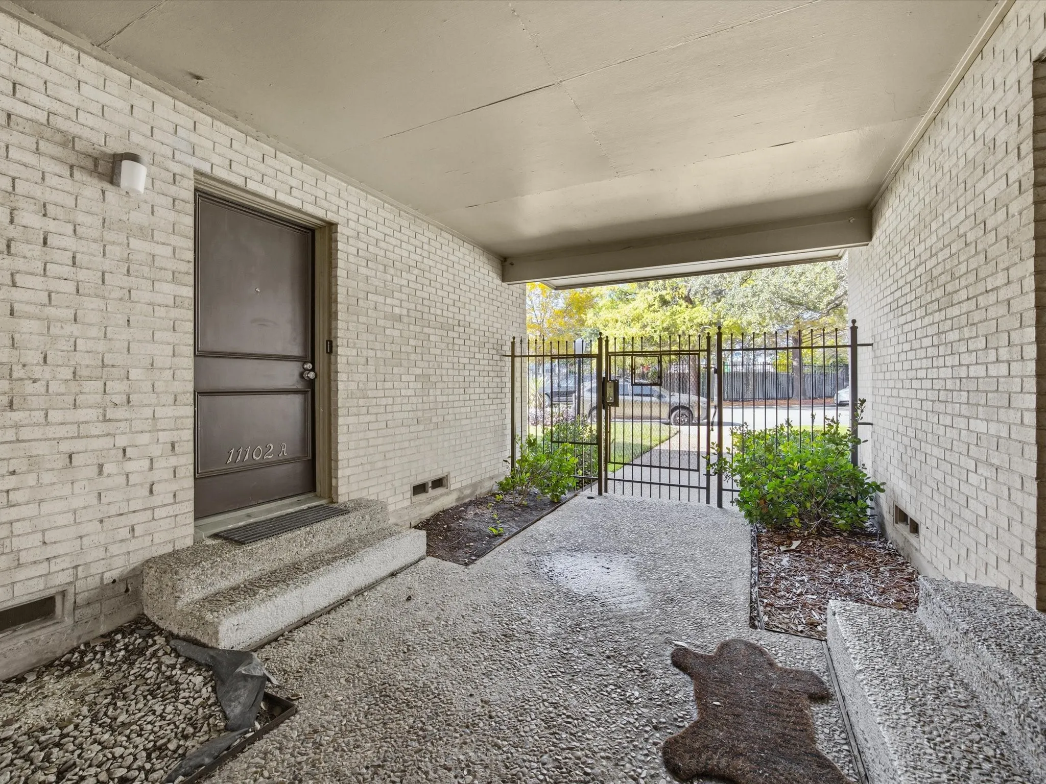 View of patio featuring a gate