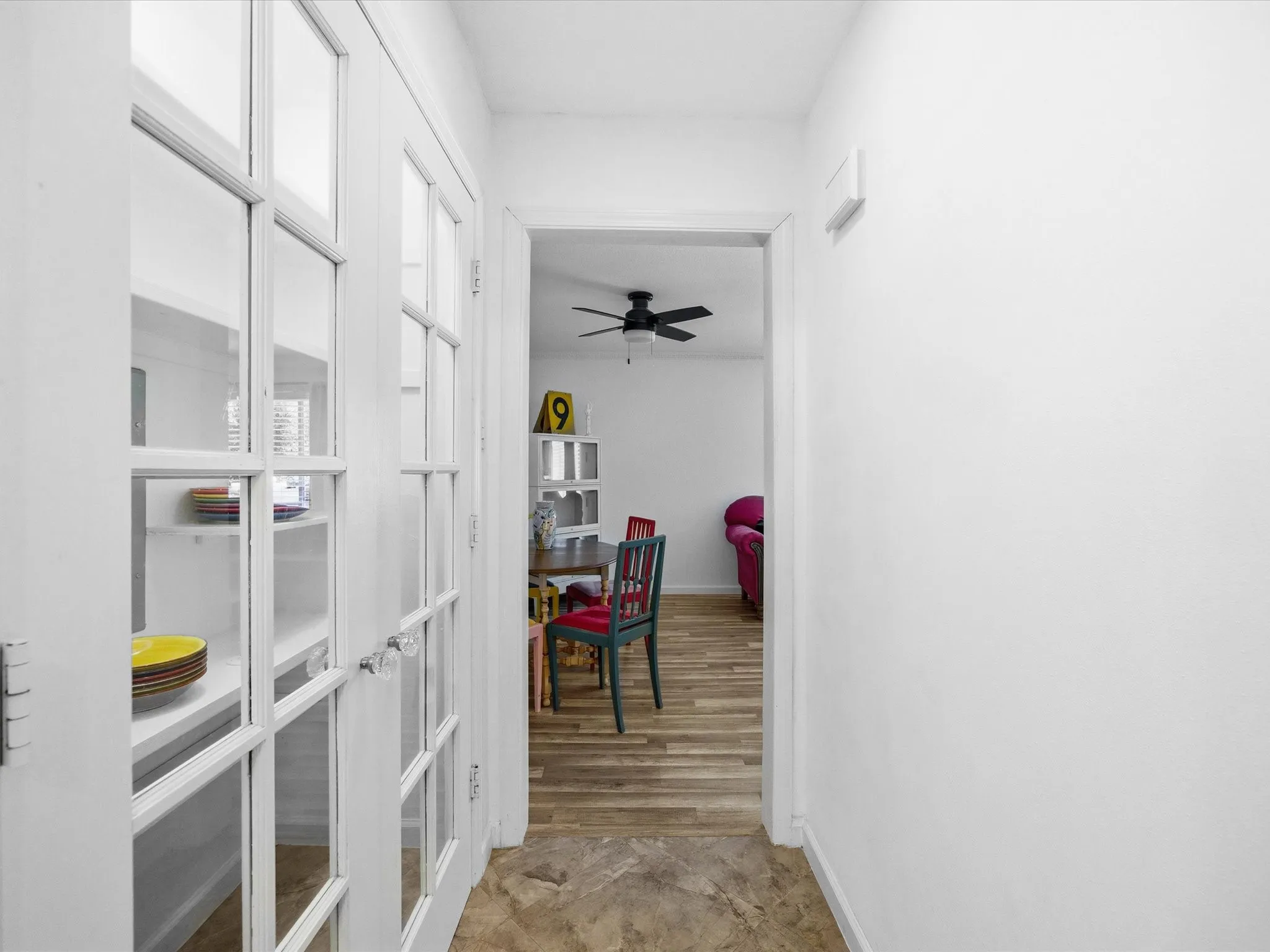 Corridor with baseboards and french doors
