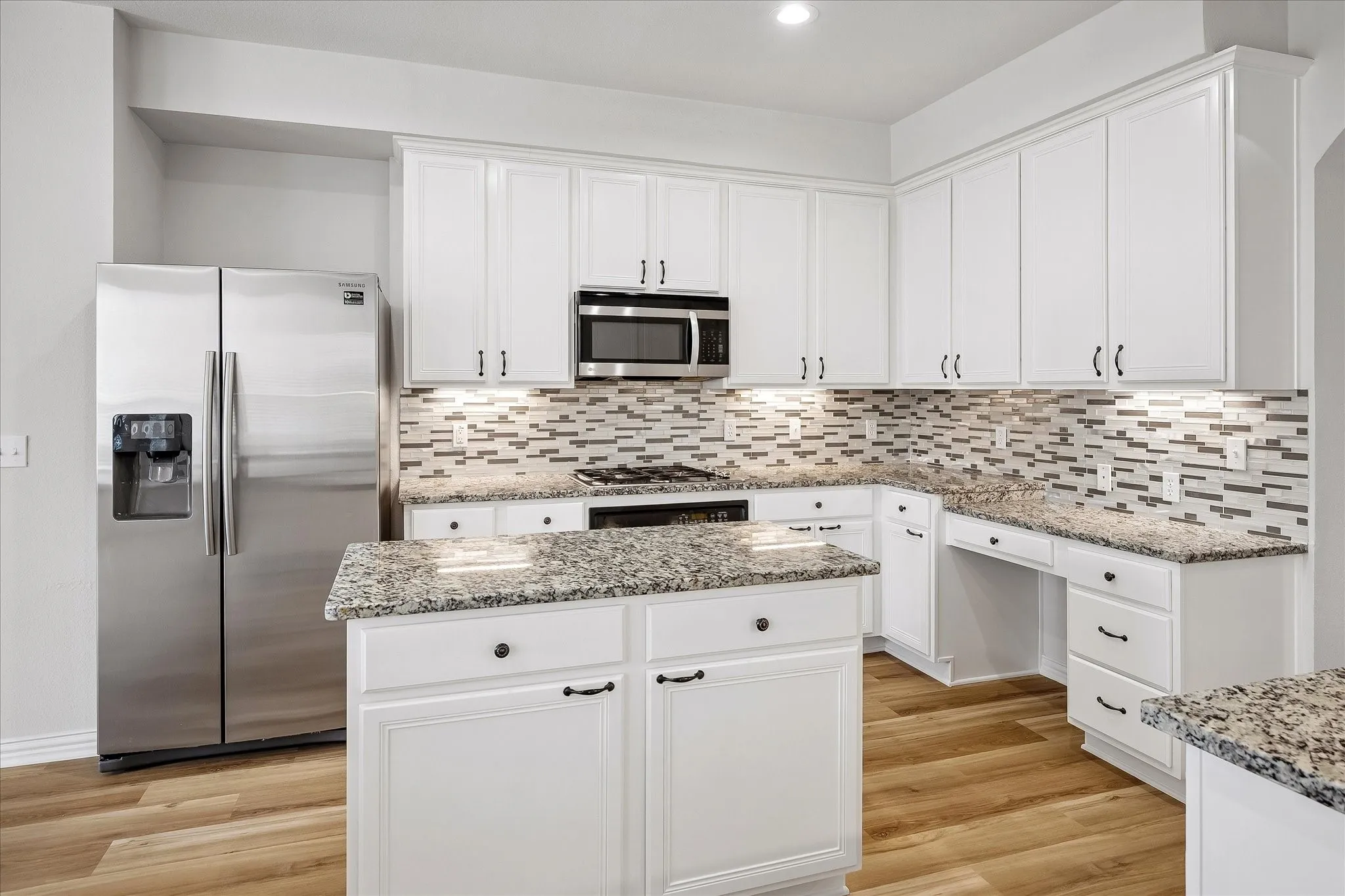 Kitchen featuring white cabinetry, granite countertops, and wood-finish flooring
