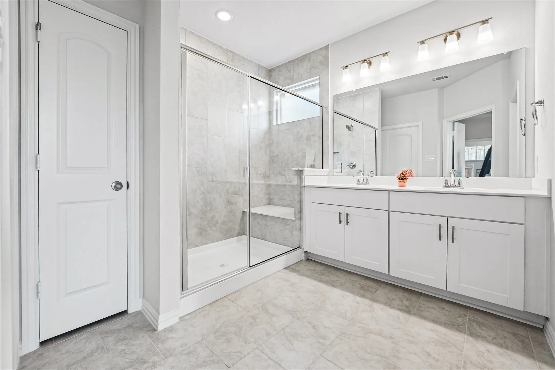 Double vanity with white cabinetry, ample countertop space, and dual sinks