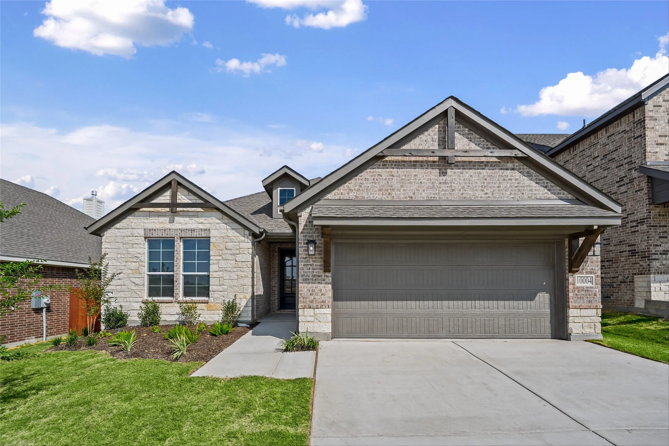 Stone and brick exterior with a two-car garage