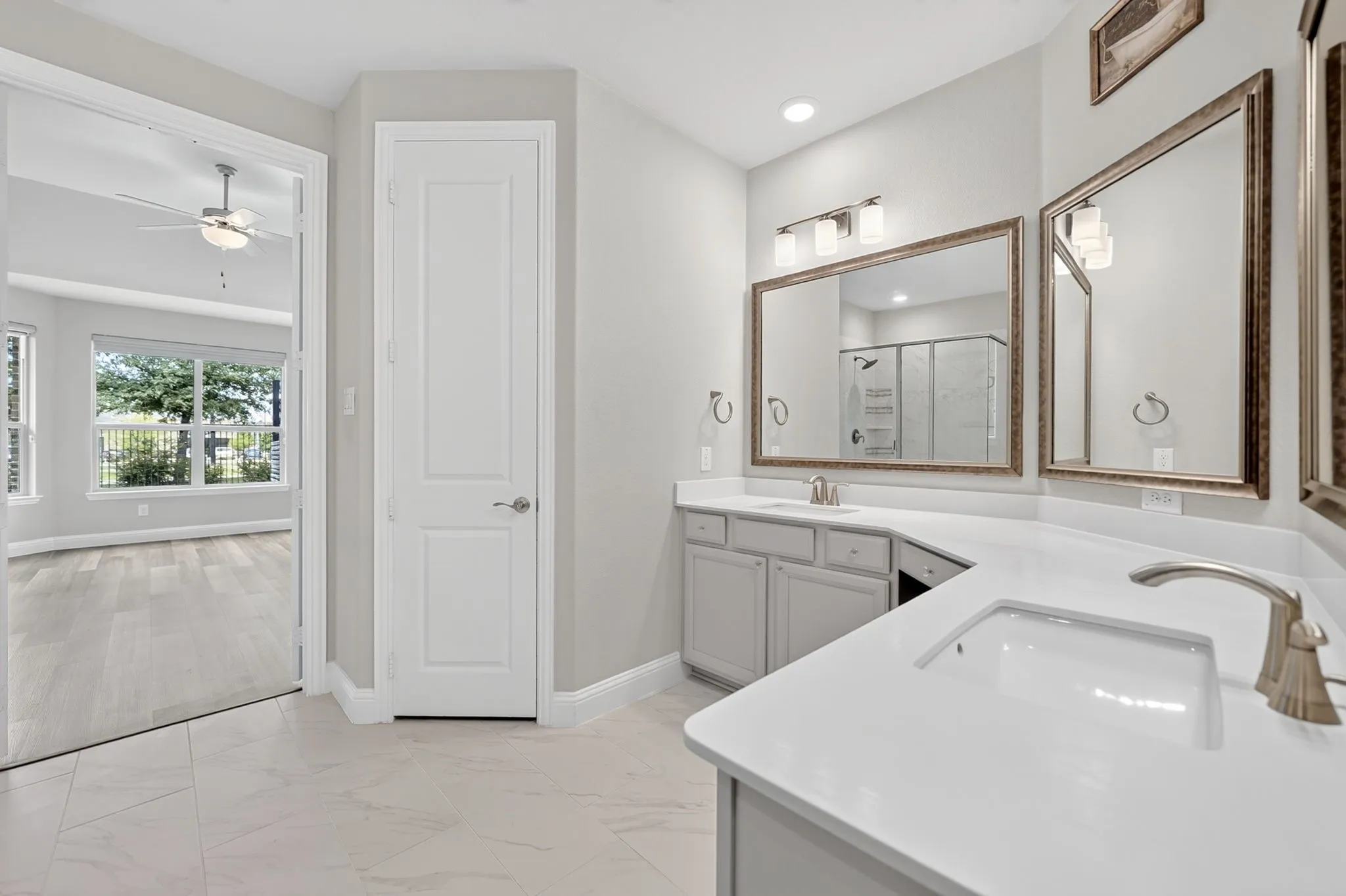 Spacious bathroom featuring dual vanity with quartz countertops, undermount sinks, and brushed nickel fixtures