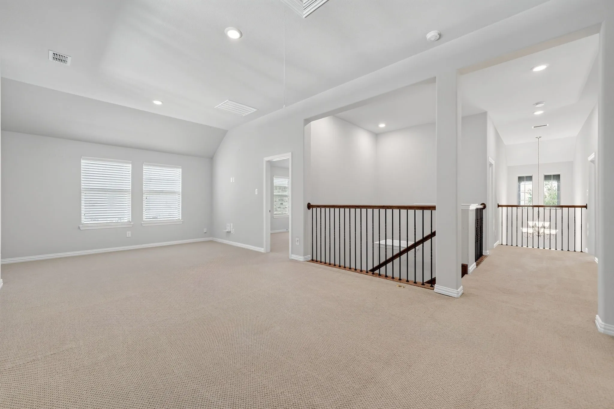 Spacious secondary living area featuring neutral carpeting and light gray walls