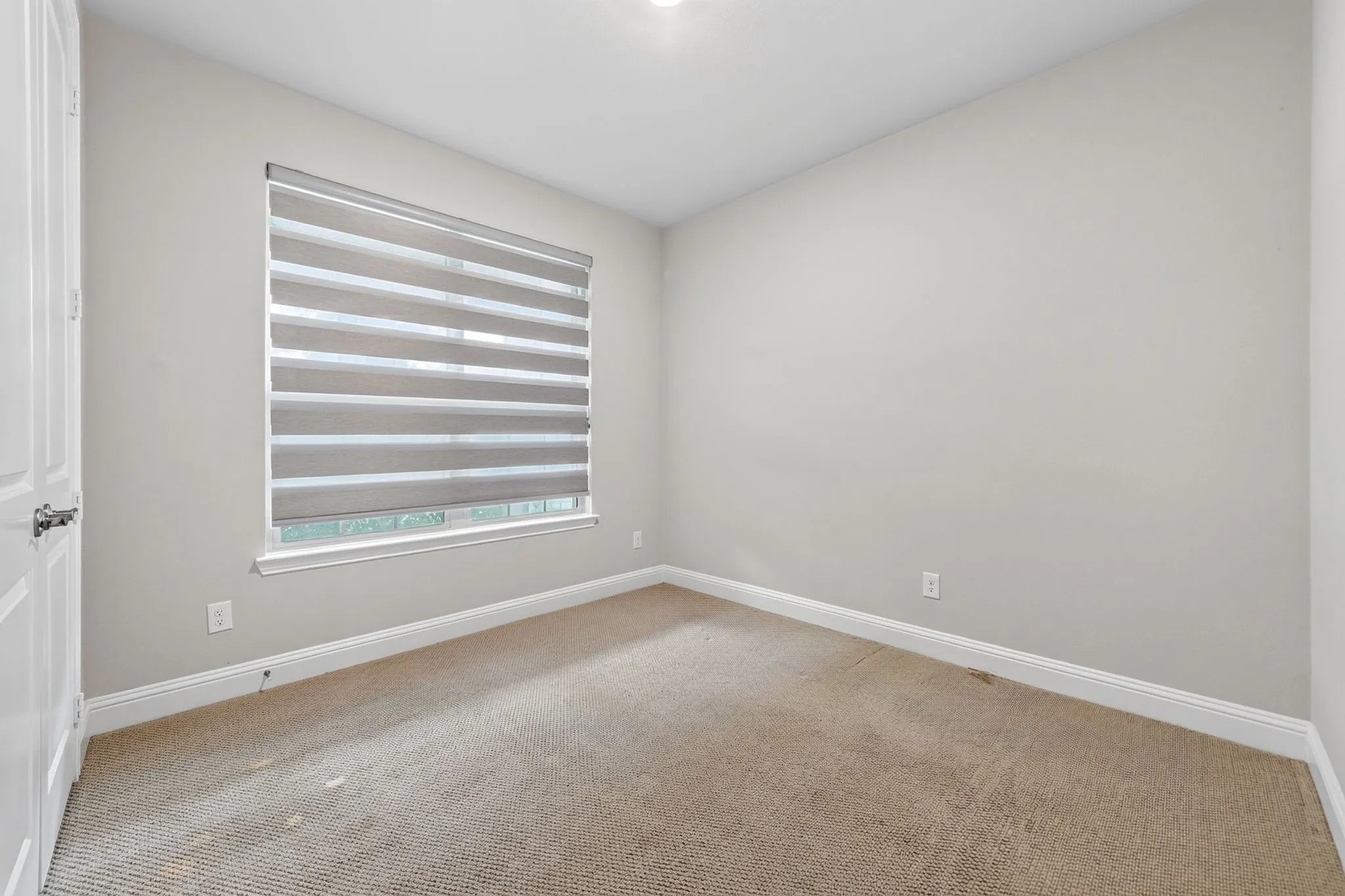 Neutral-toned carpeting paired with light gray wall paint