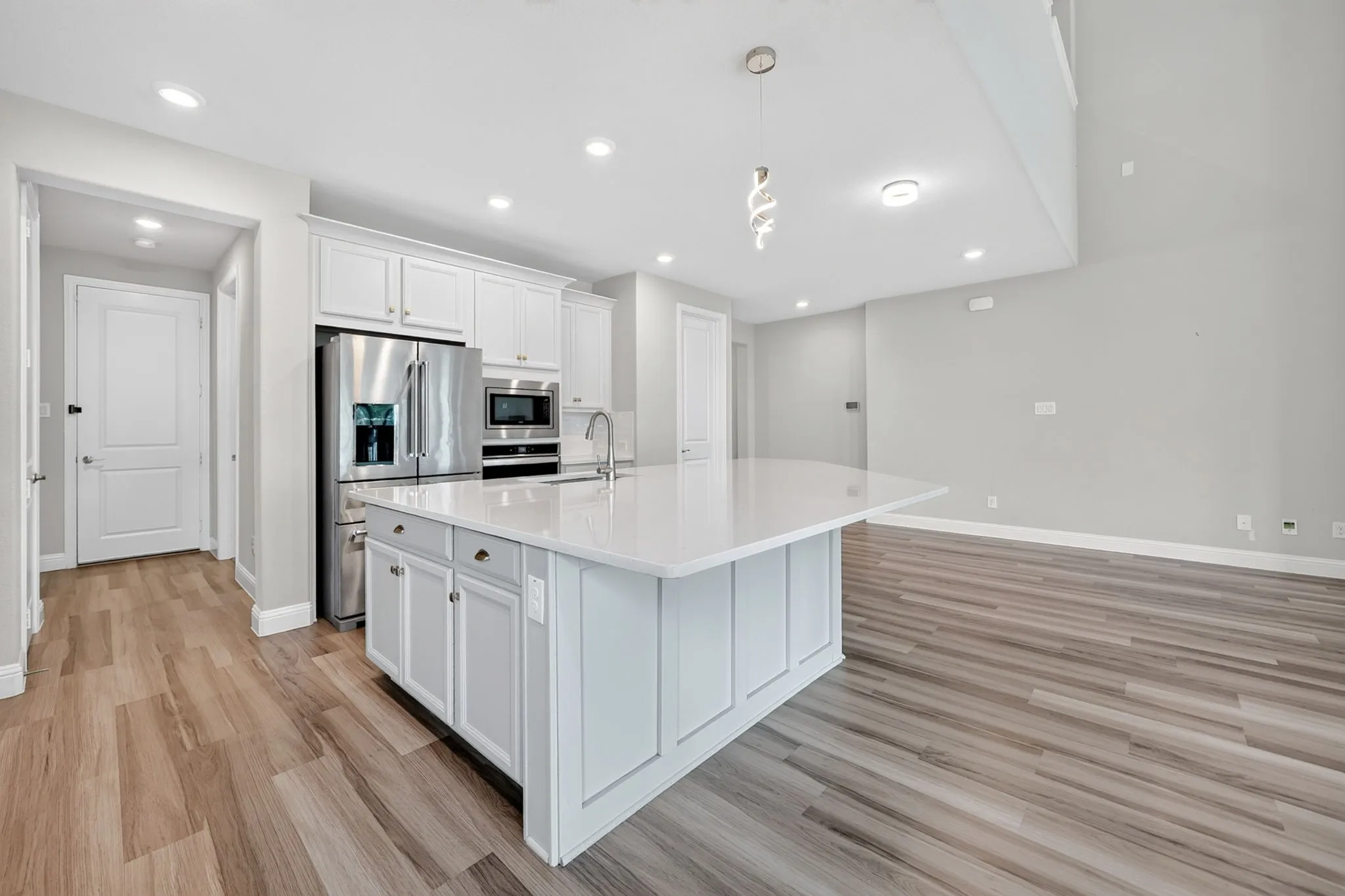 Kitchen island featuring a white countertop and light-colored cabinetry