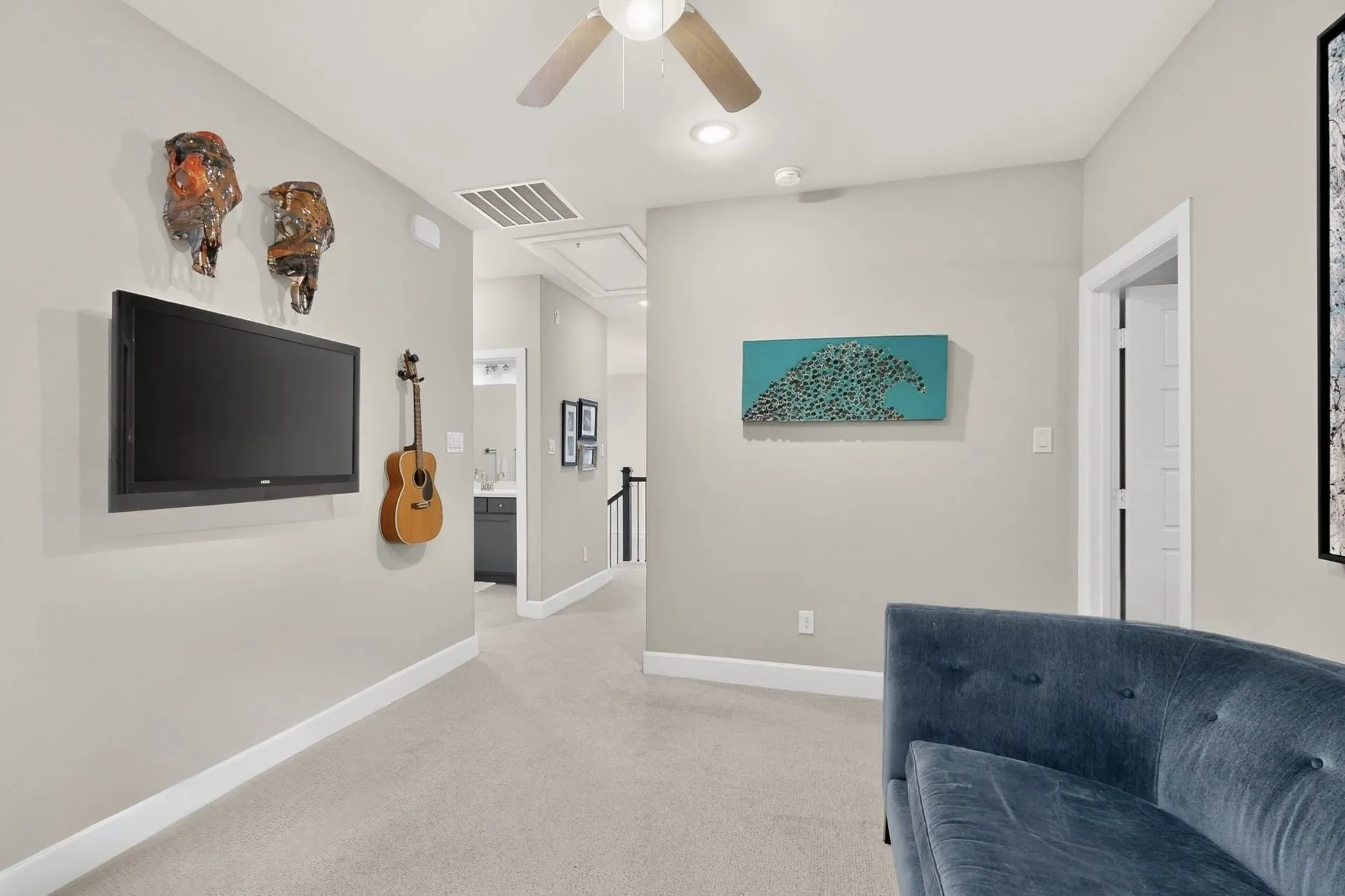 Carpeted room with a ceiling fan, recessed lighting, and white baseboards