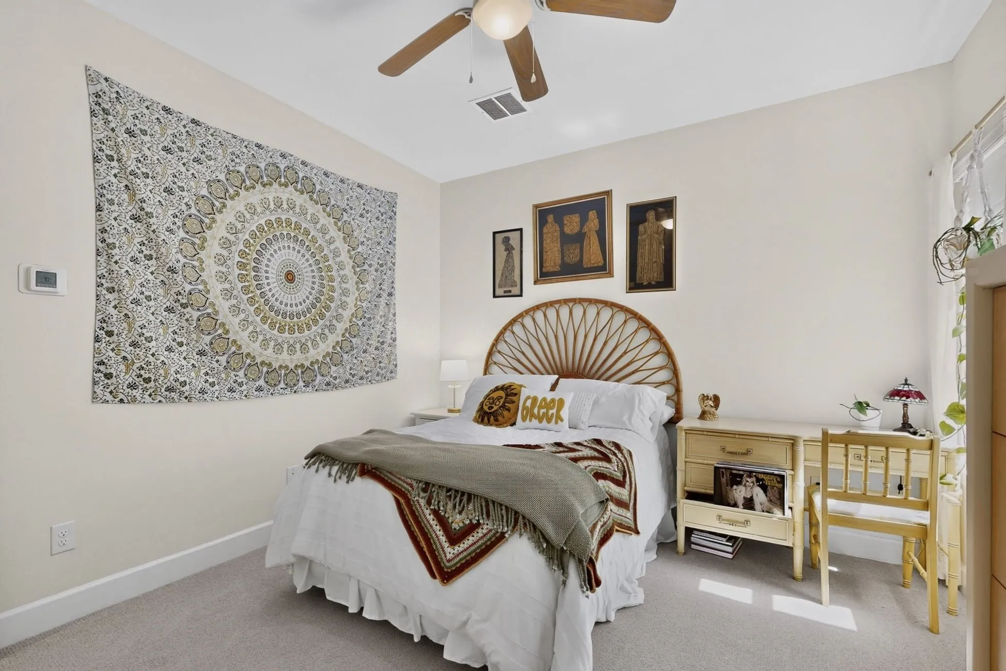 Carpeted room featuring a ceiling fan, baseboard molding, and light-colored walls