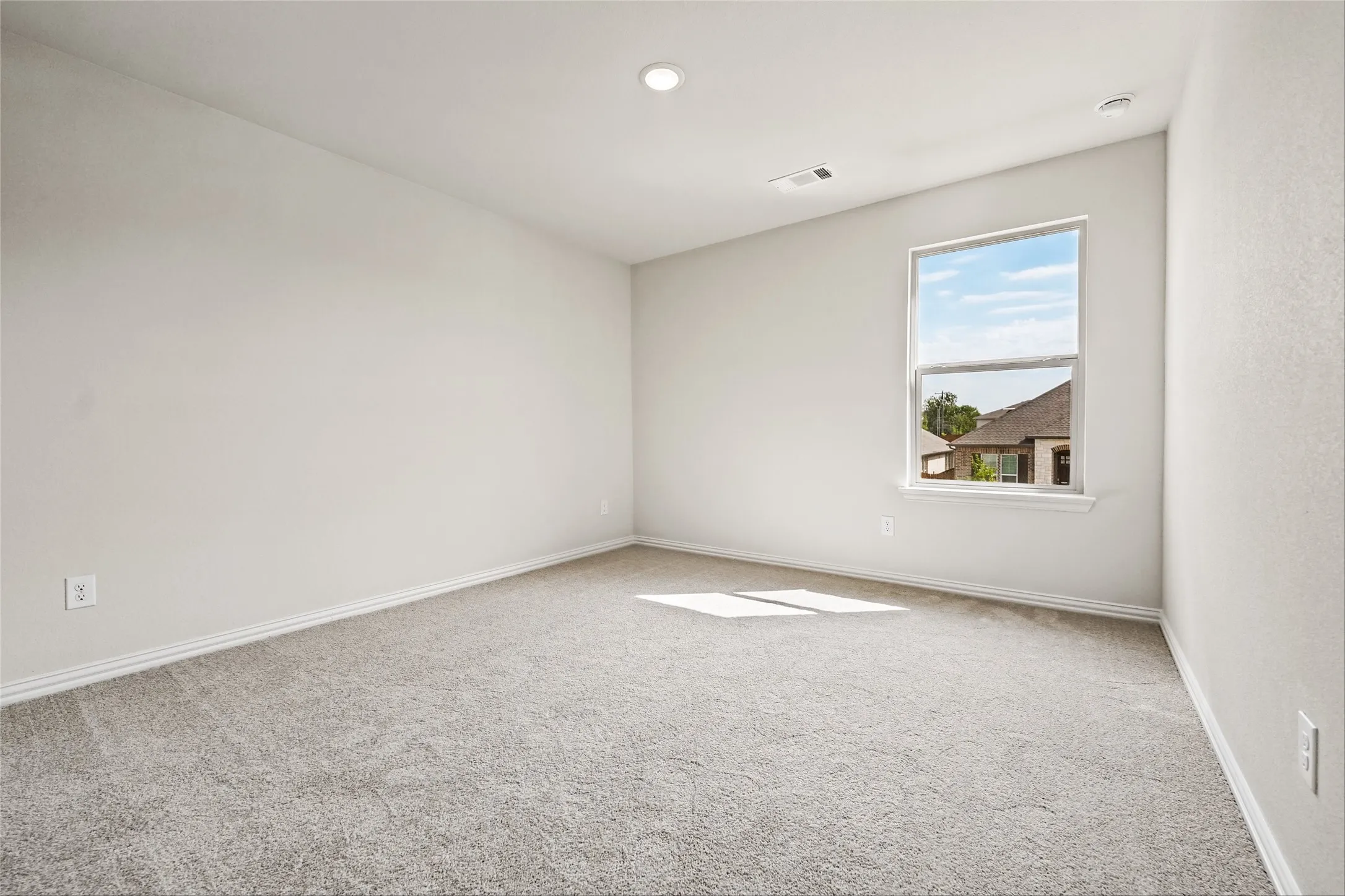 Recessed lighting, light-toned carpeting, single window, and light-colored walls