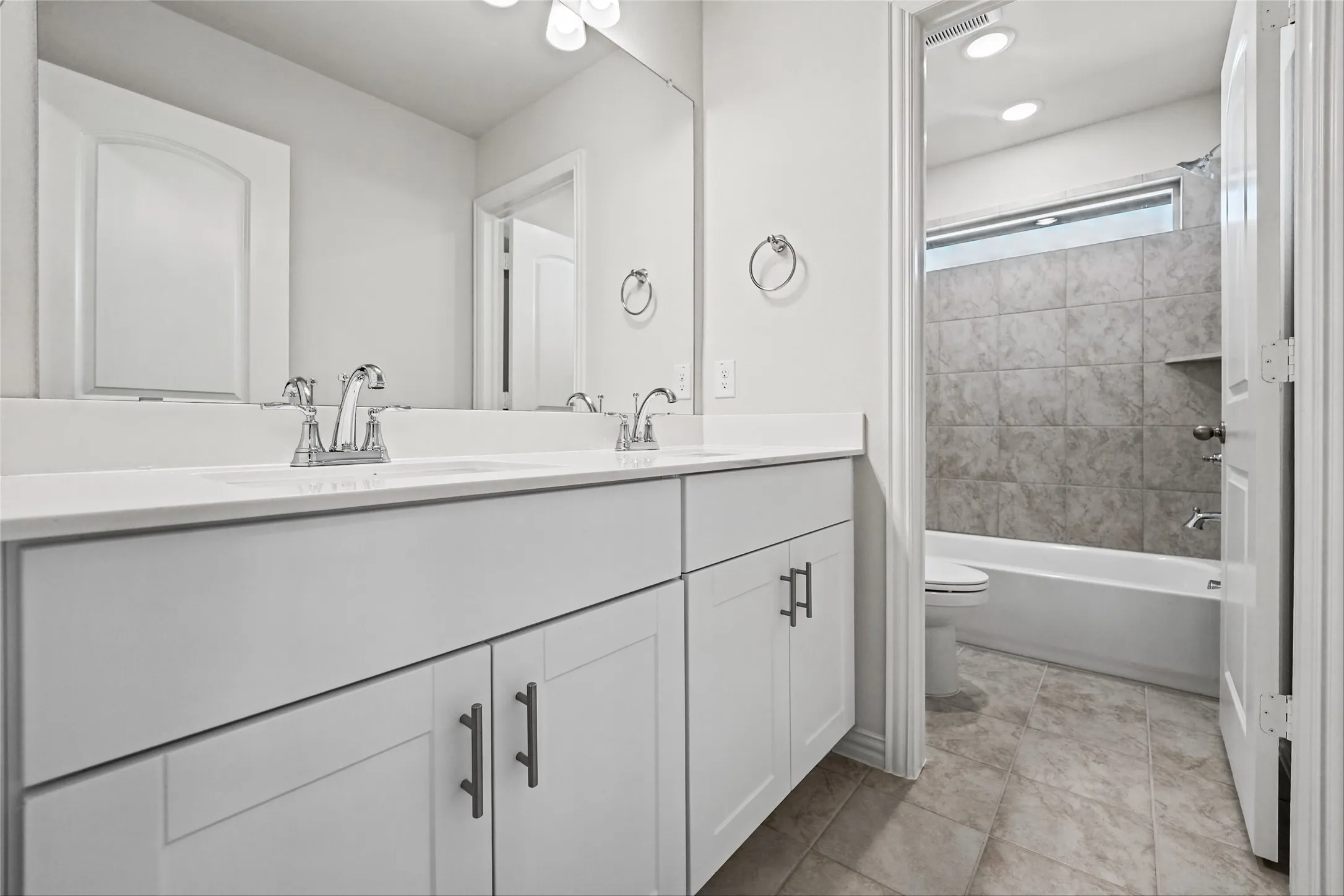 Dual vanity with white cabinetry and chrome fixtures