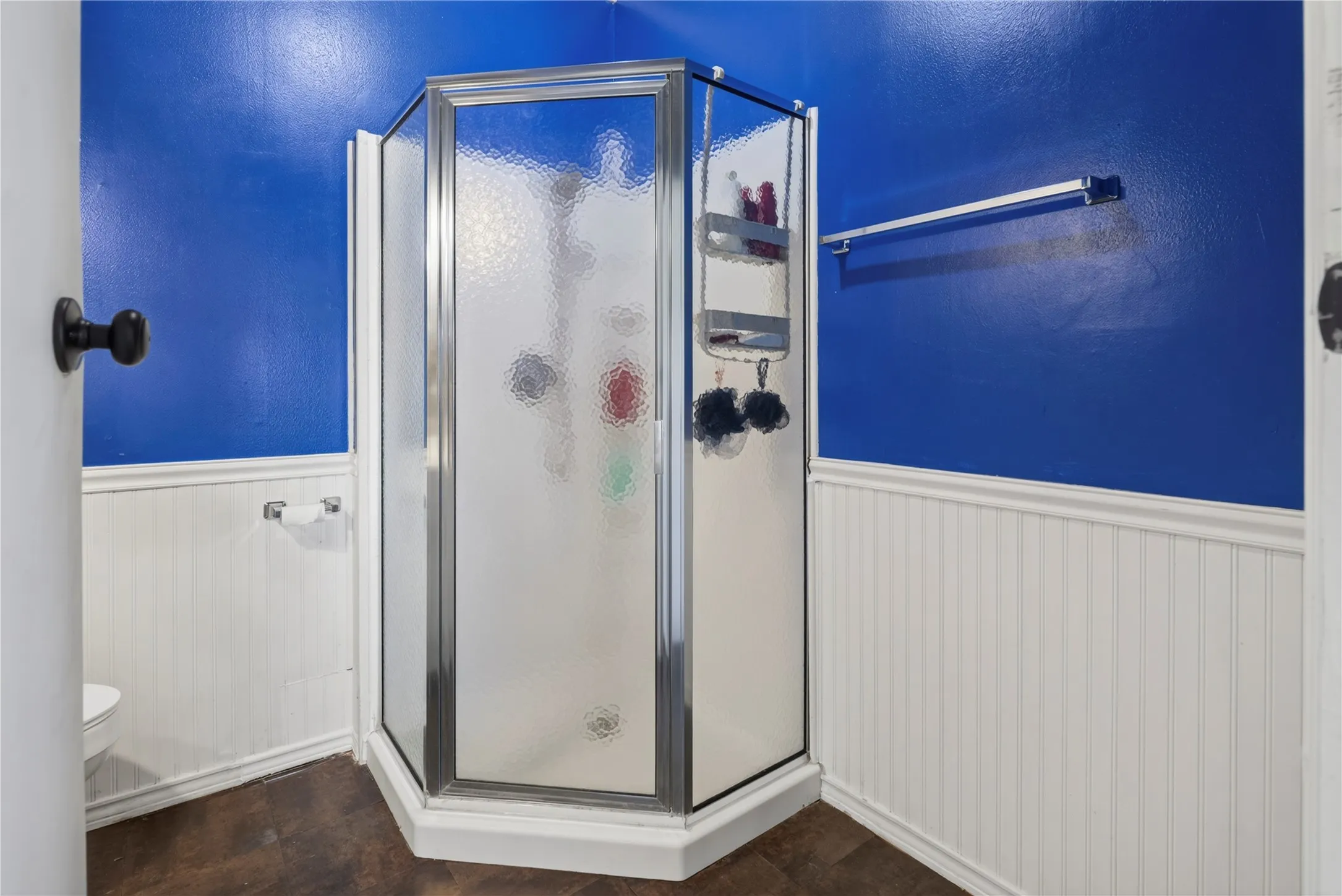 Corner shower enclosure with frosted glass panels and a chrome frame