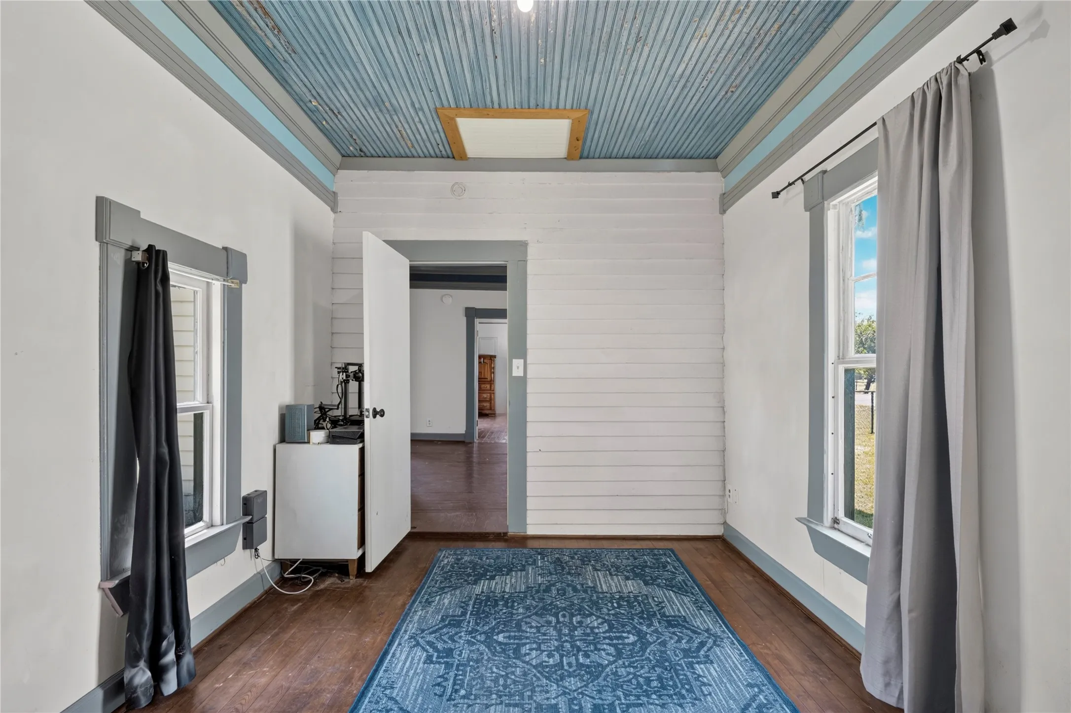 White panel door featuring a decorative arched window and a pet door insert