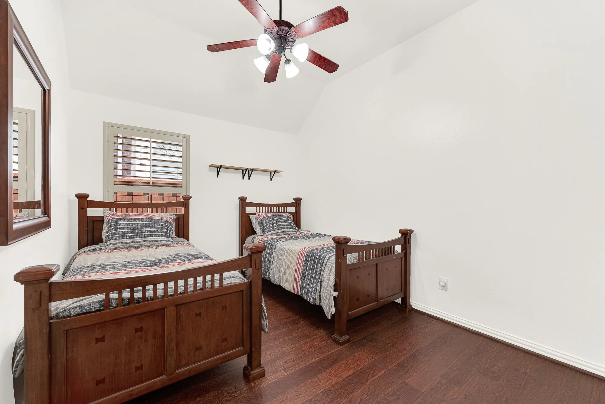 The vaulted ceiling and rich wood flooring create an airy, comfortable retreat with room for multiple furniture arrangements. It's an inviting space for kids, guests, or a home office that easily adapts as your needs change.