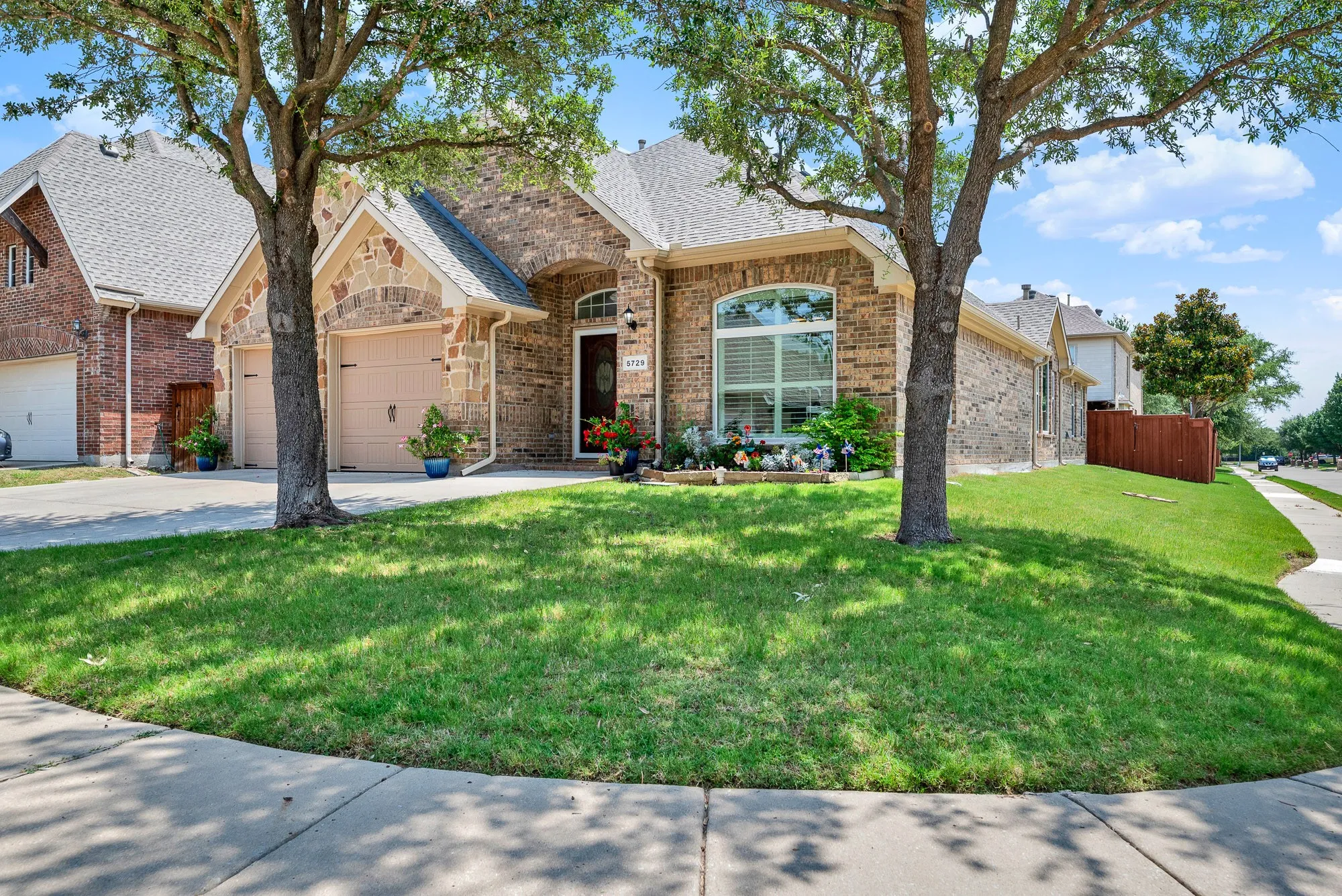 The generous corner lot allows sunlight to surround the home while mature trees provide welcome shade throughout the day. Picture evening walks through the neighborhood before relaxing in the peaceful setting of your own front yard.
