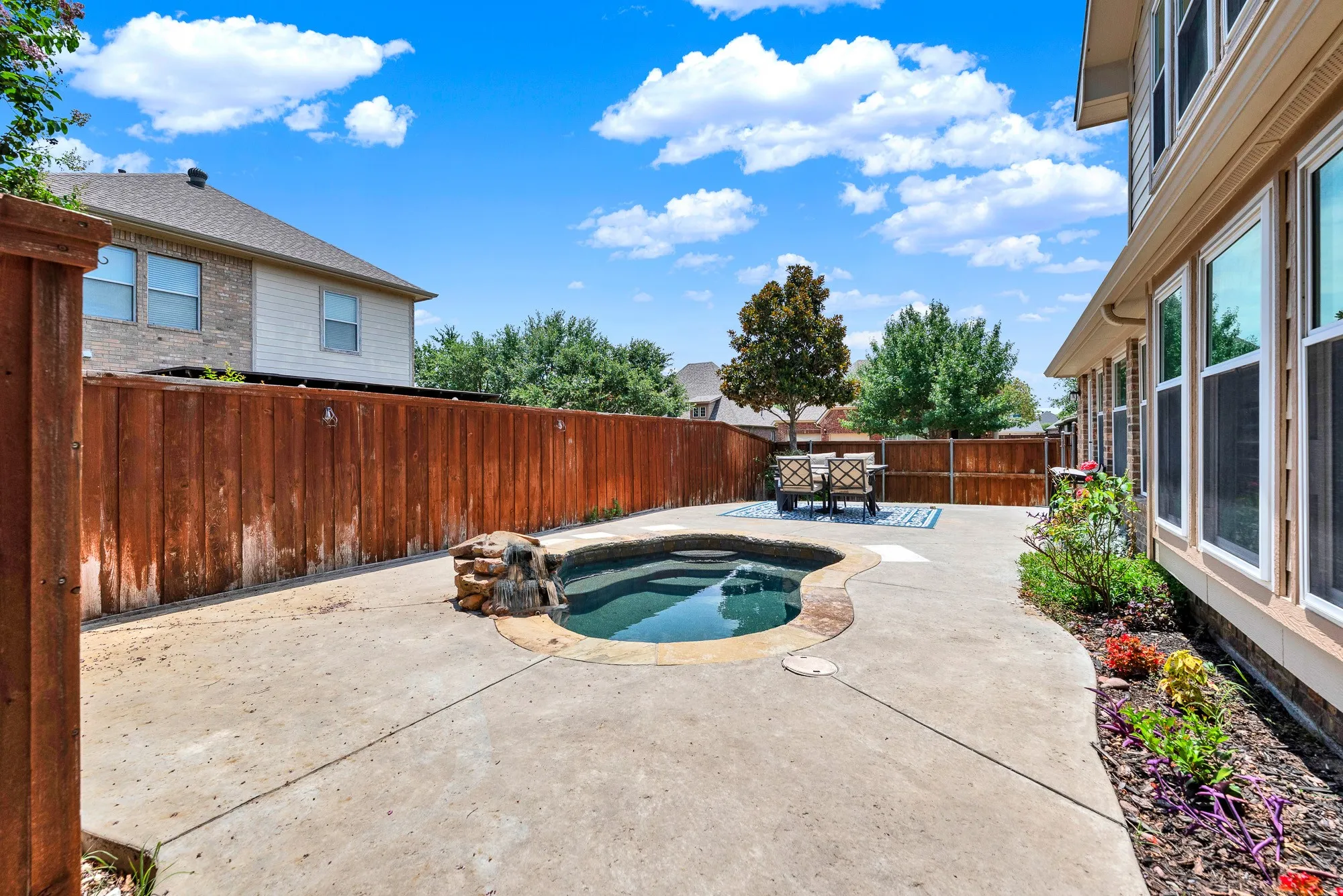 The oversized concrete patio offers plenty of room for outdoor dining, lounging, or future entertaining spaces around the spa. Enjoy weekends spent grilling, relaxing, and making the most of your own backyard escape.