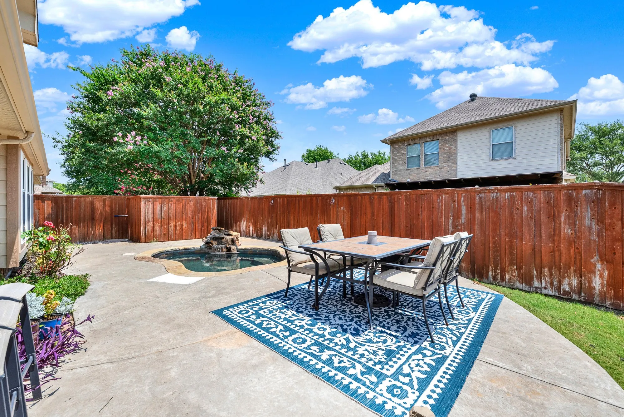 The large patio offers plenty of room for outdoor meals, lounging, and entertaining, with the spa creating a relaxing focal point. Picture weekend barbecues with friends followed by an evening soak under the Texas sky.