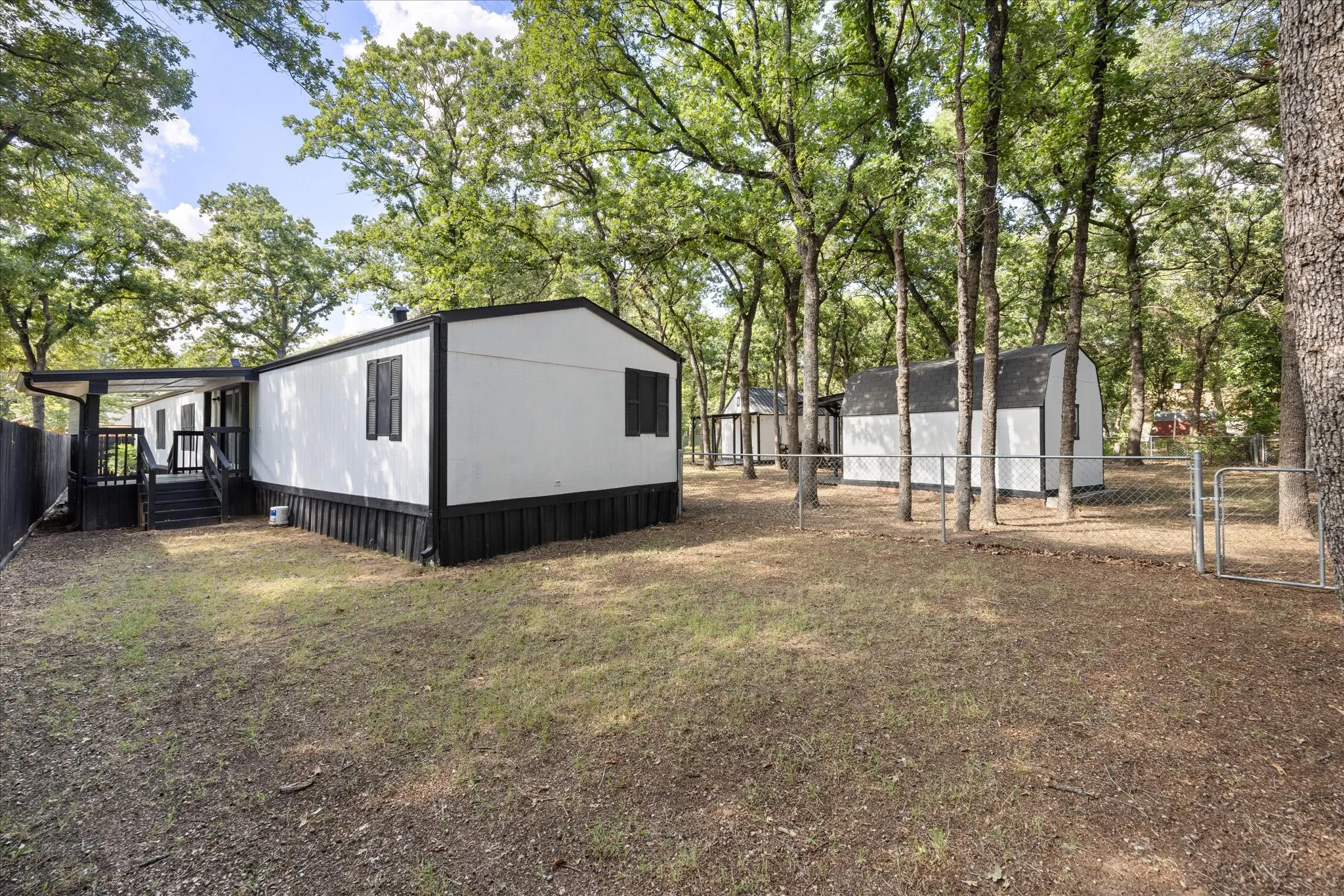 Back of the property with 2 fenced areas 4617 Lyndi Ln
Granbury, TX  76049