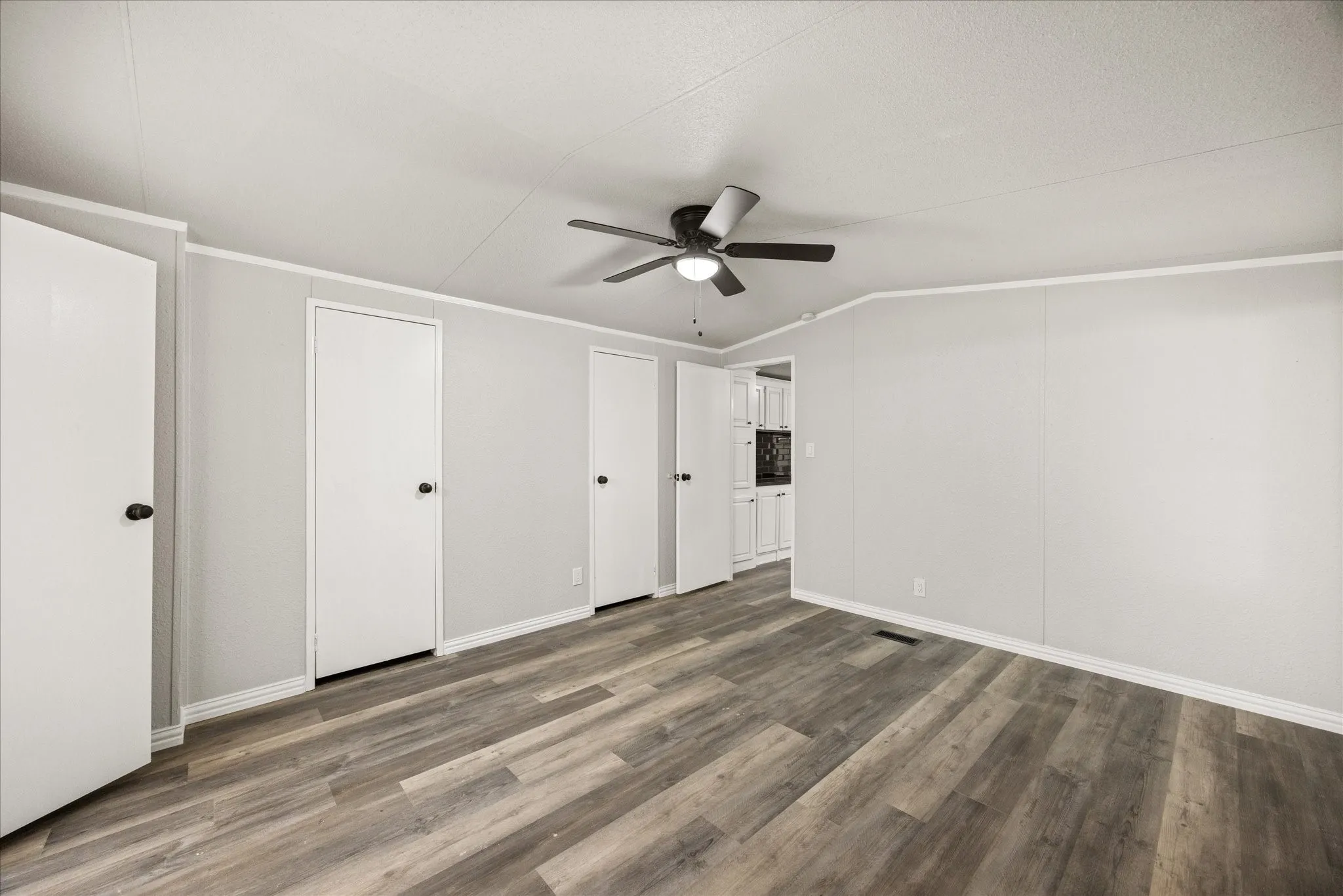 Spacious room featuring wood-finish flooring, white baseboards, and a ceiling fan with integrated lighting 4617 Lyndi Ln
Granbury, TX  76049