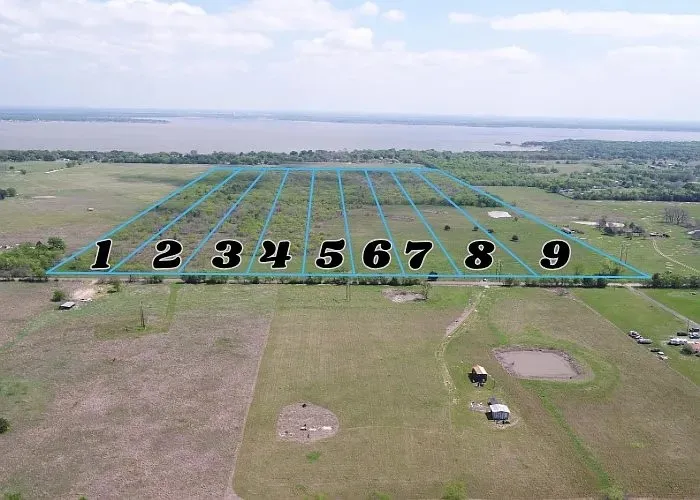 Aerial overview of a large land parcel featuring multiple subdivided lots