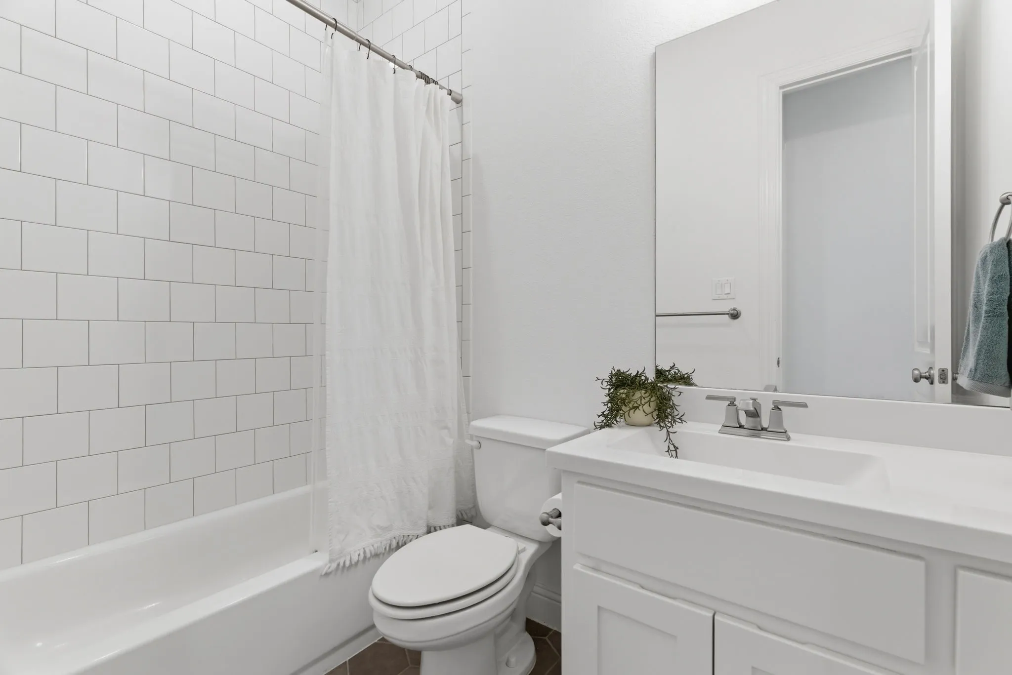 Secondary bath on main floor located adjacent to secondary main floor bedroom.
