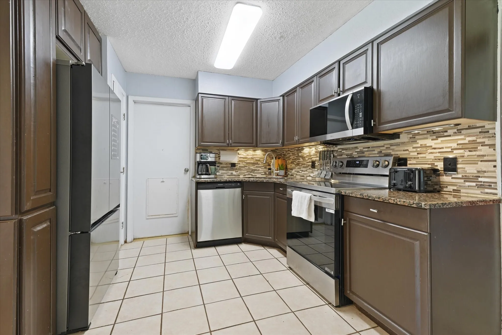 Kitchen with granite counter tops and stainless appliances