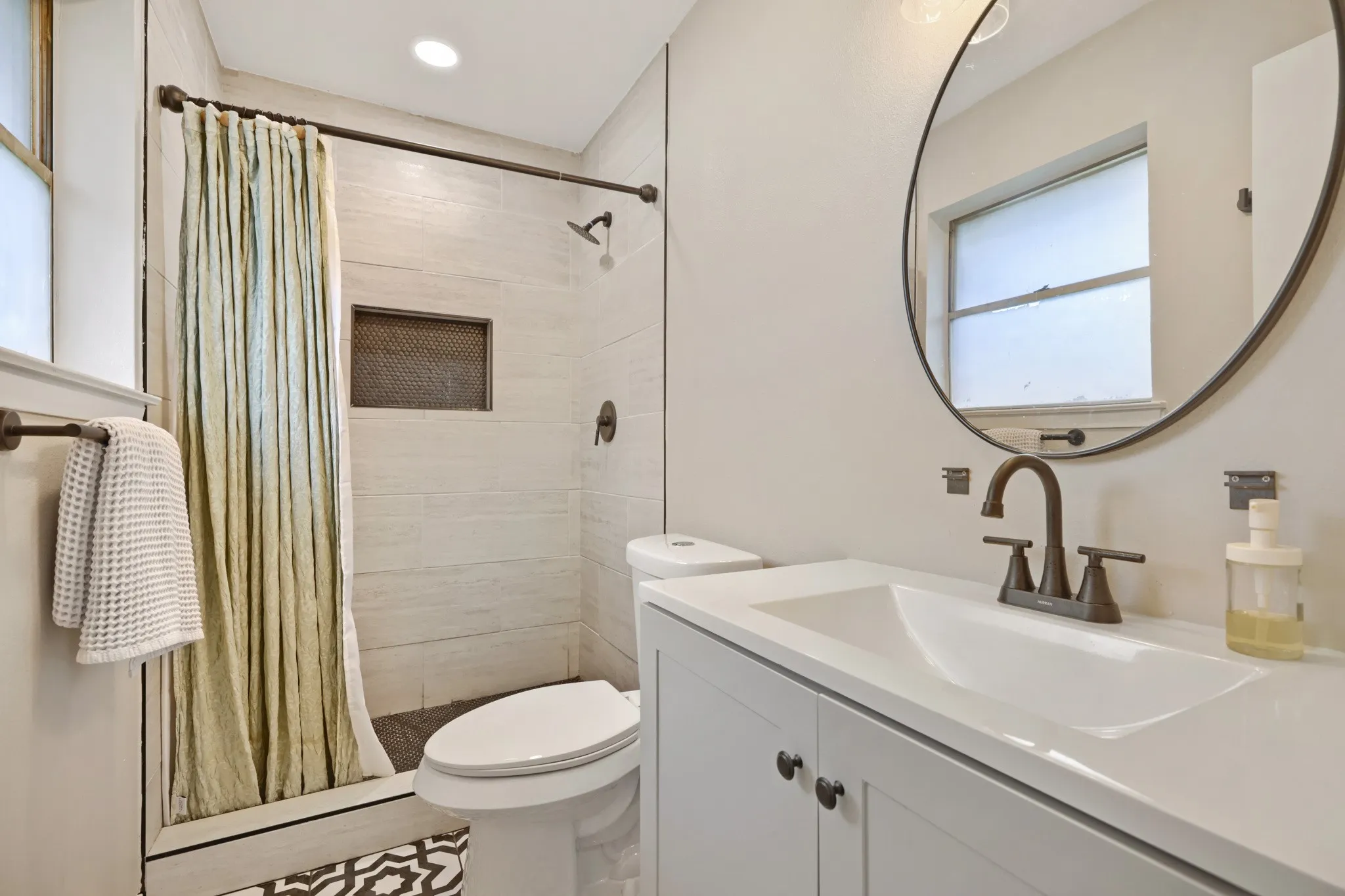 Primary bathroom featuring walk-in shower and designer tile install
