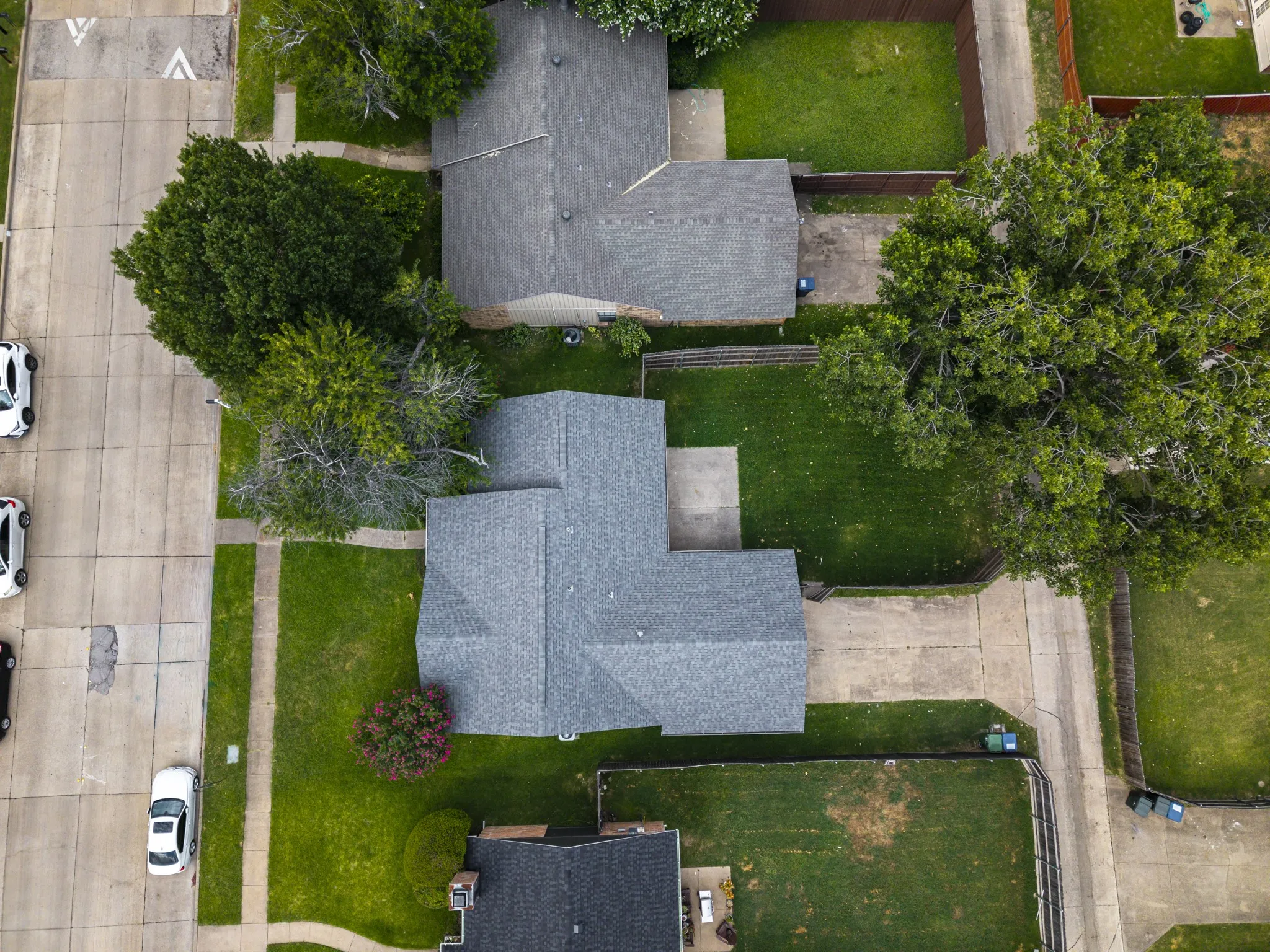 Gable roof home featuring a concrete driveway and an expansive front lawn