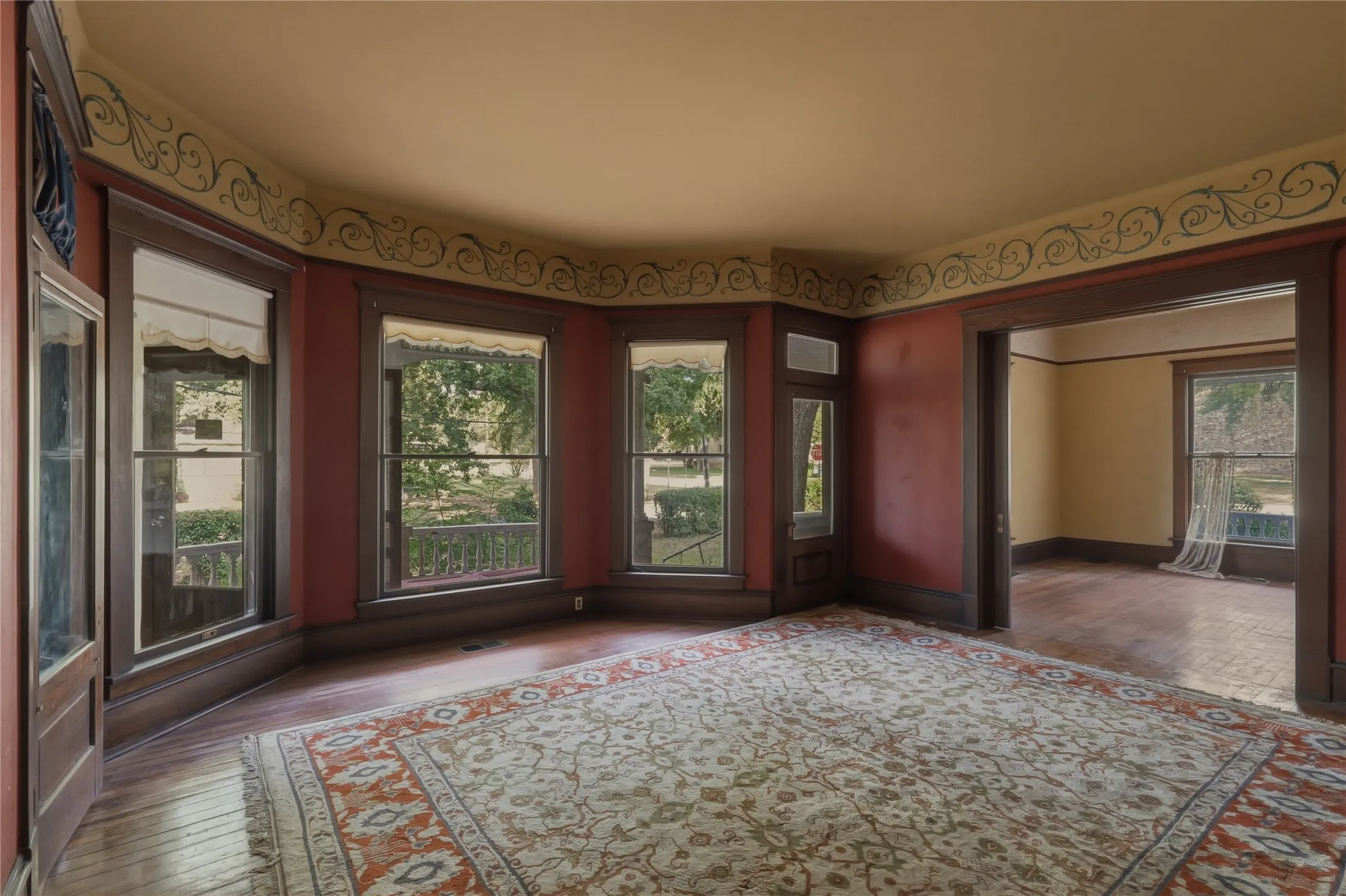 Living area with wood detailing, and a wall of windows.