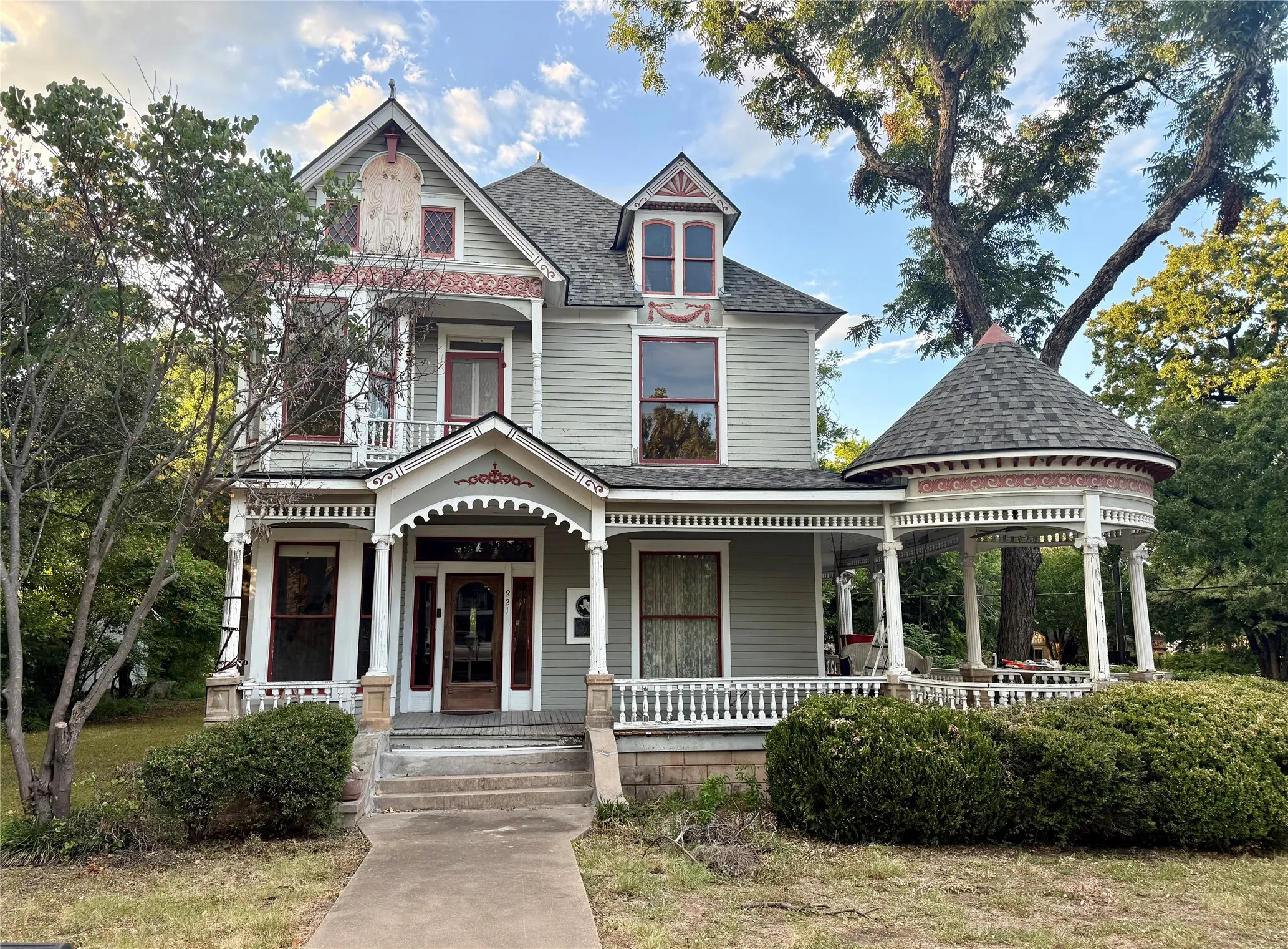 Front of home featuring extensive porches and stunning architectural details