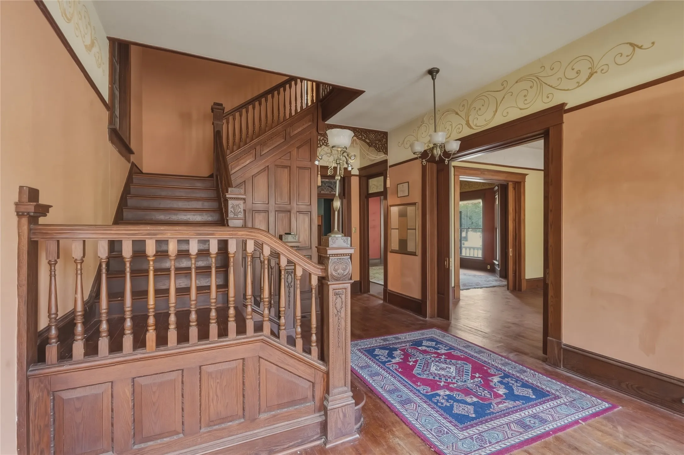 Extraordinary entrance with intricate staircase woodworking