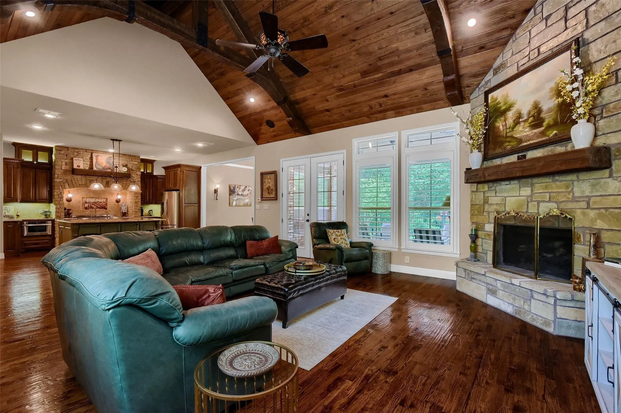 Living area with vaulted wood-plank ceiling and exposed beams