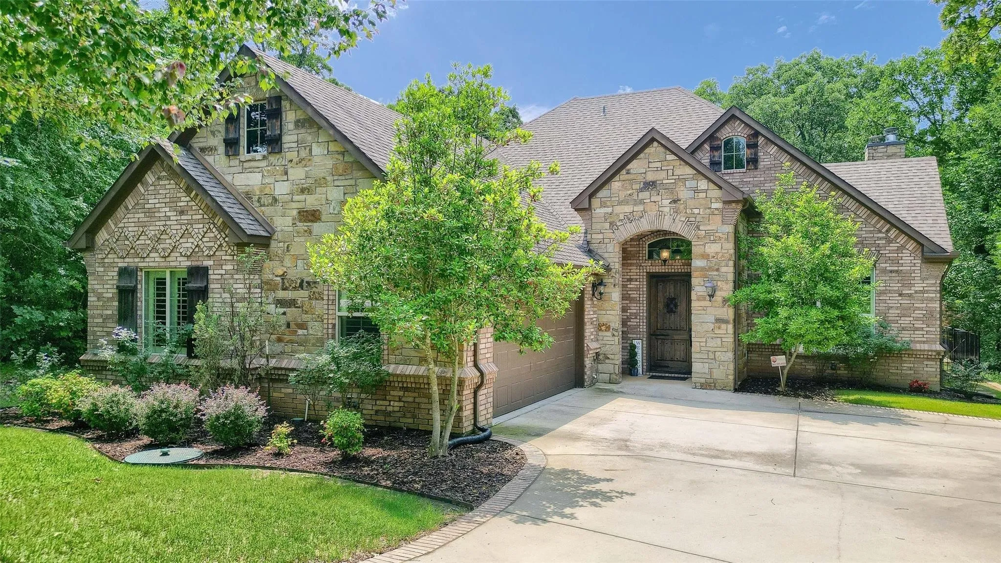 Stone and brick exterior with contrasting dark window shutters