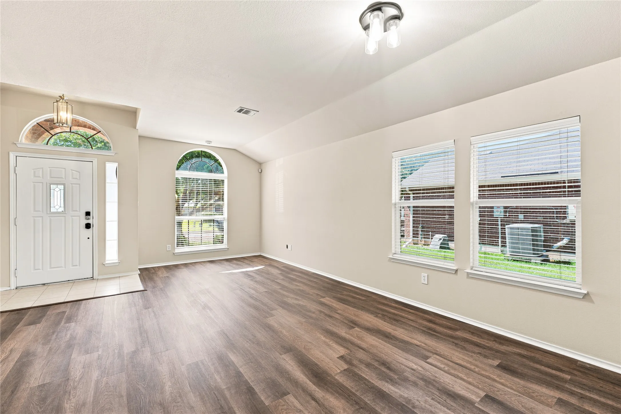 Entry foyer featuring a transom window above the paneled door with sidelight