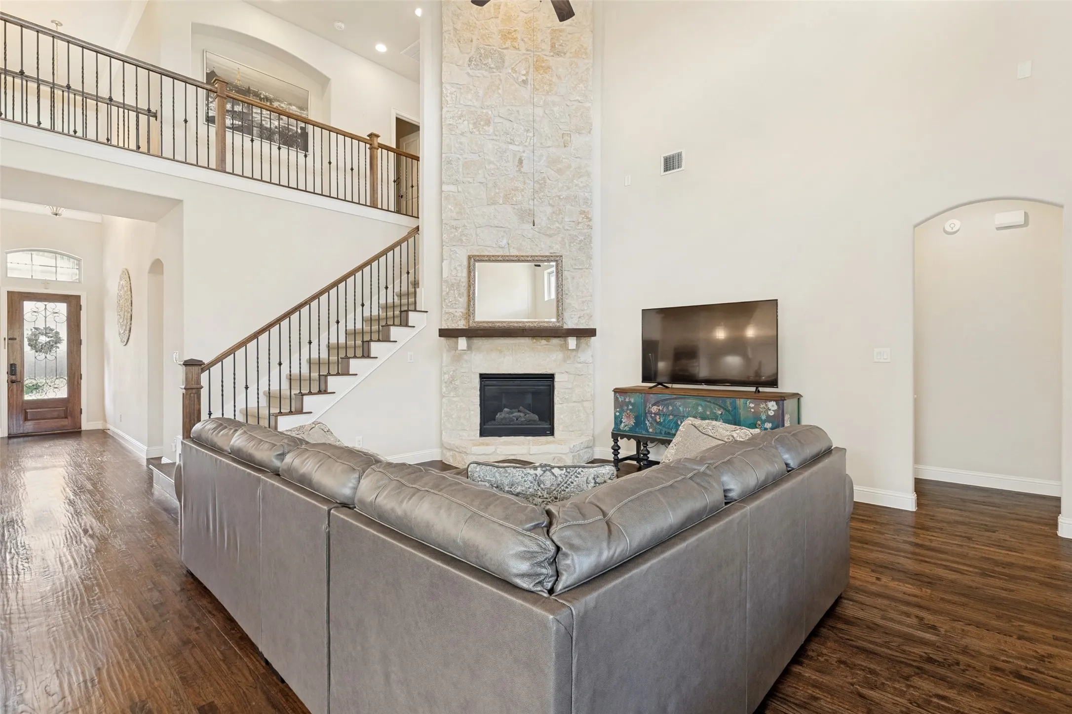 Floor to ceiling Fireplace anchors the Living space