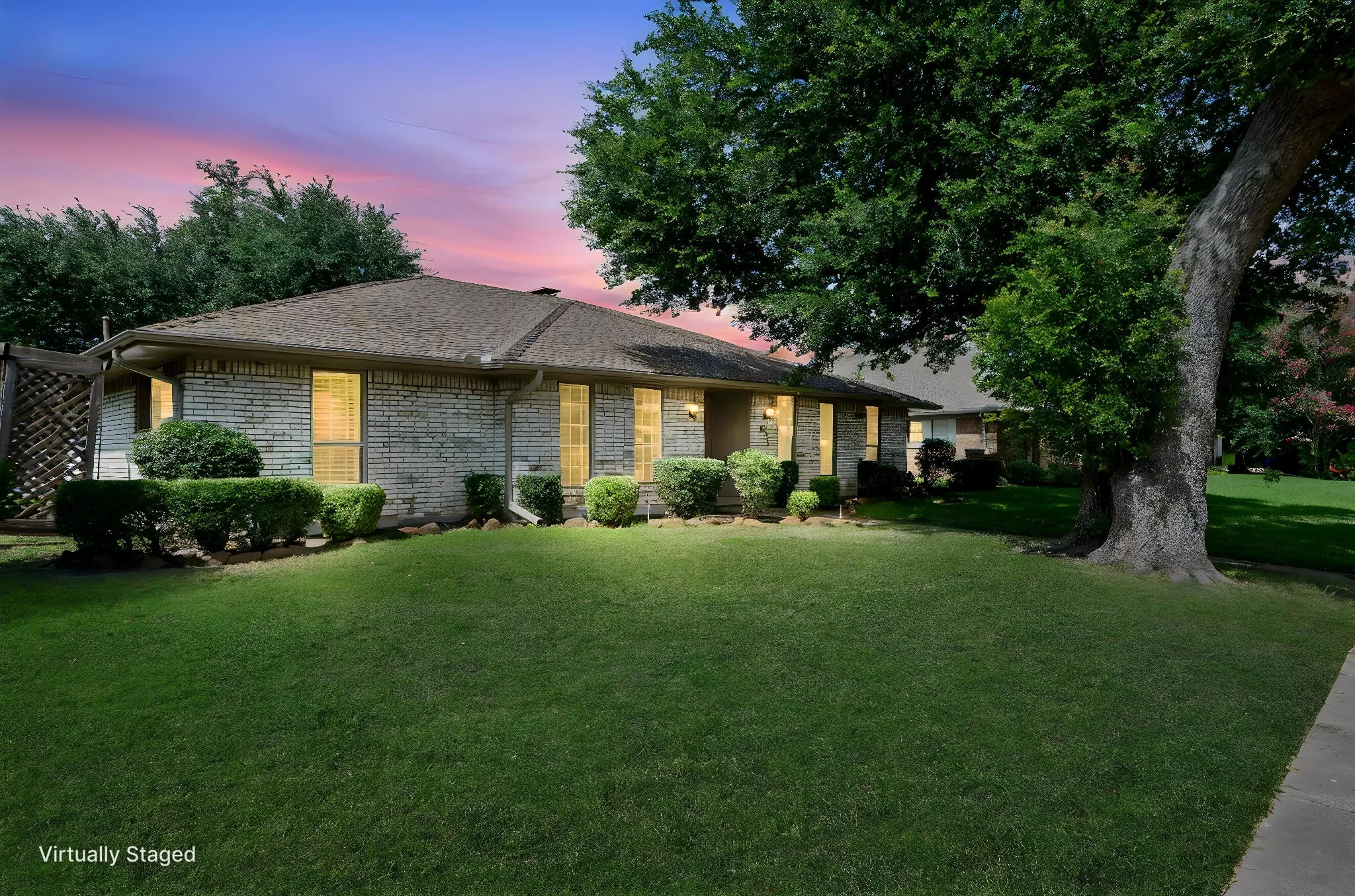 Brick exterior with a gabled roof and a vibrant green lawn
