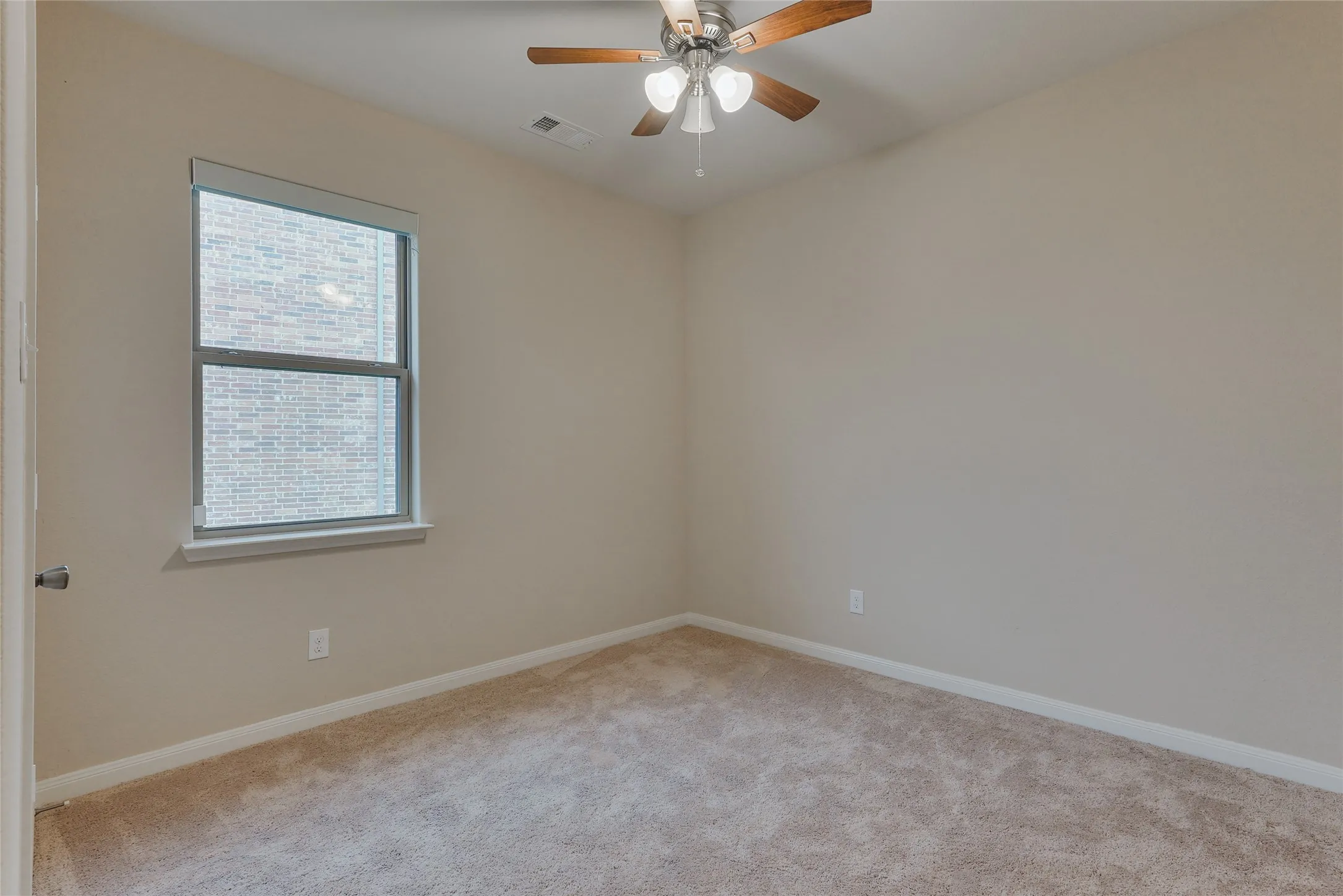 Room with neutral tone walls and coordinating carpet