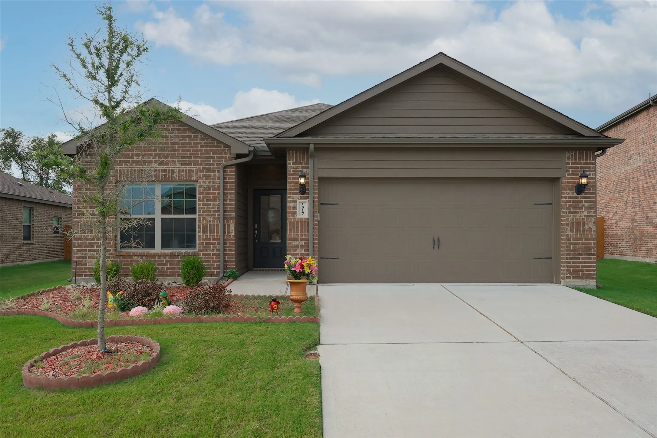 Brick exterior with a gabled roofline and an attached garage