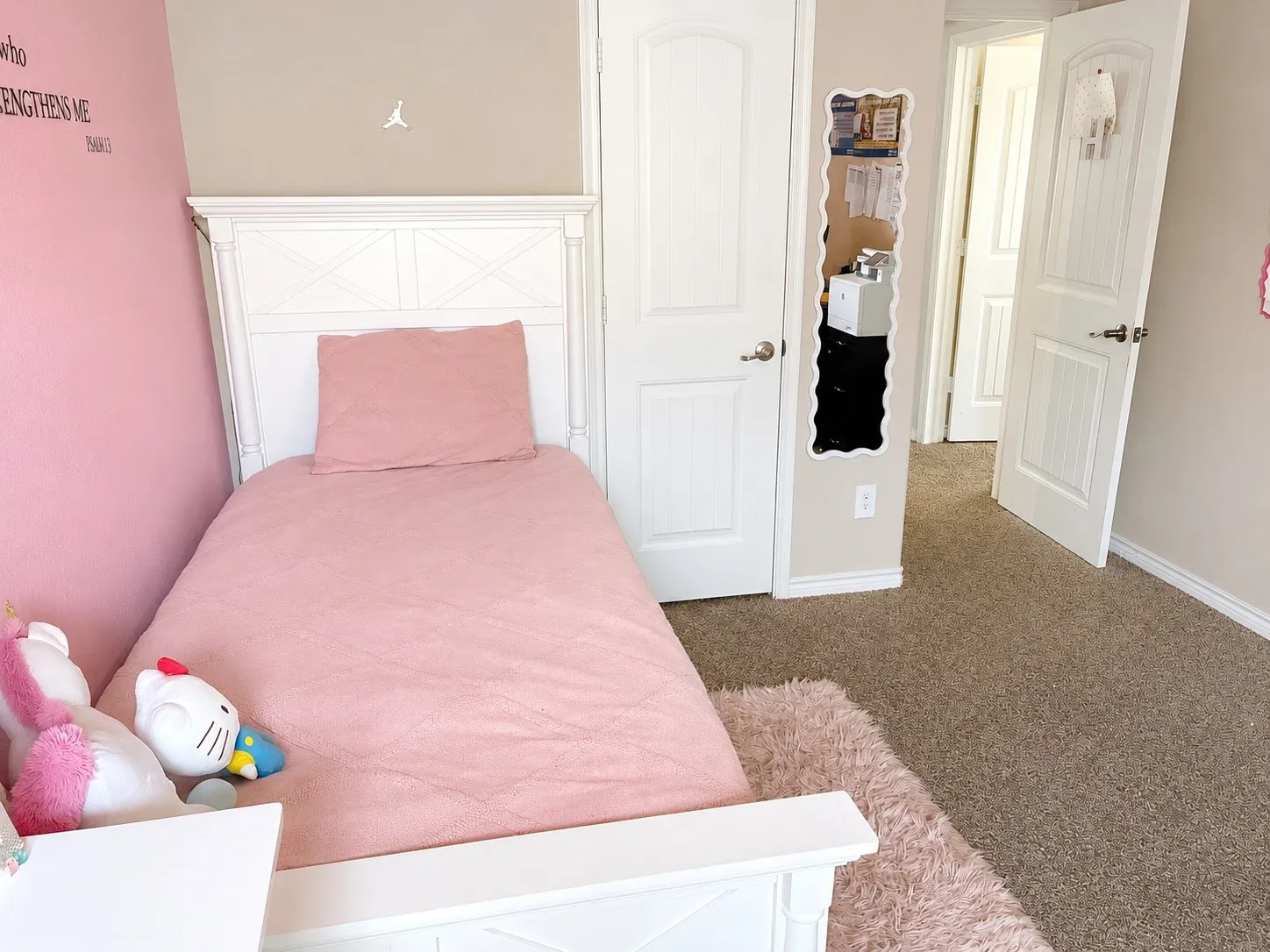Carpeted flooring throughout, featuring painted walls, and a white paneled door