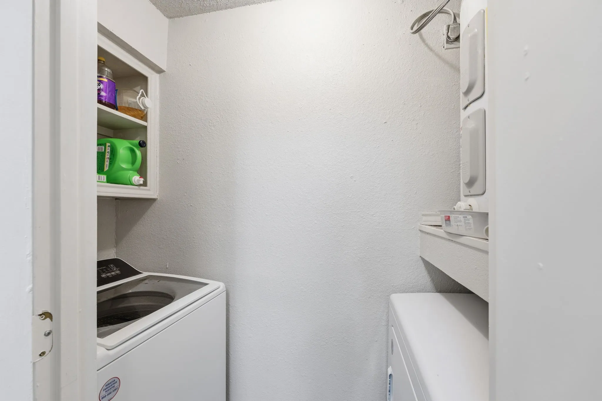 Dedicated laundry area with washer and dryer hookup + built-in shelving for storage and organization.
