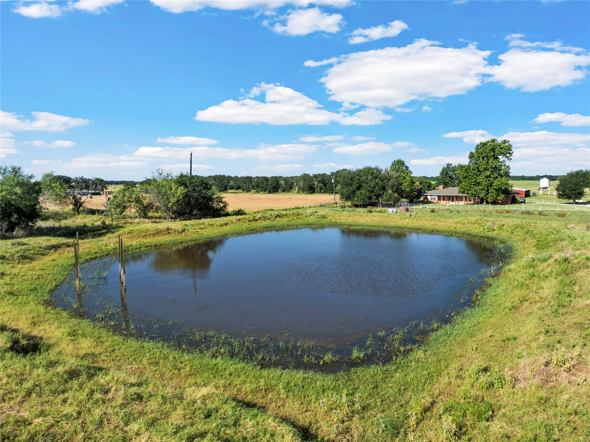 Private pond featuring natural water and surrounding grassy banks