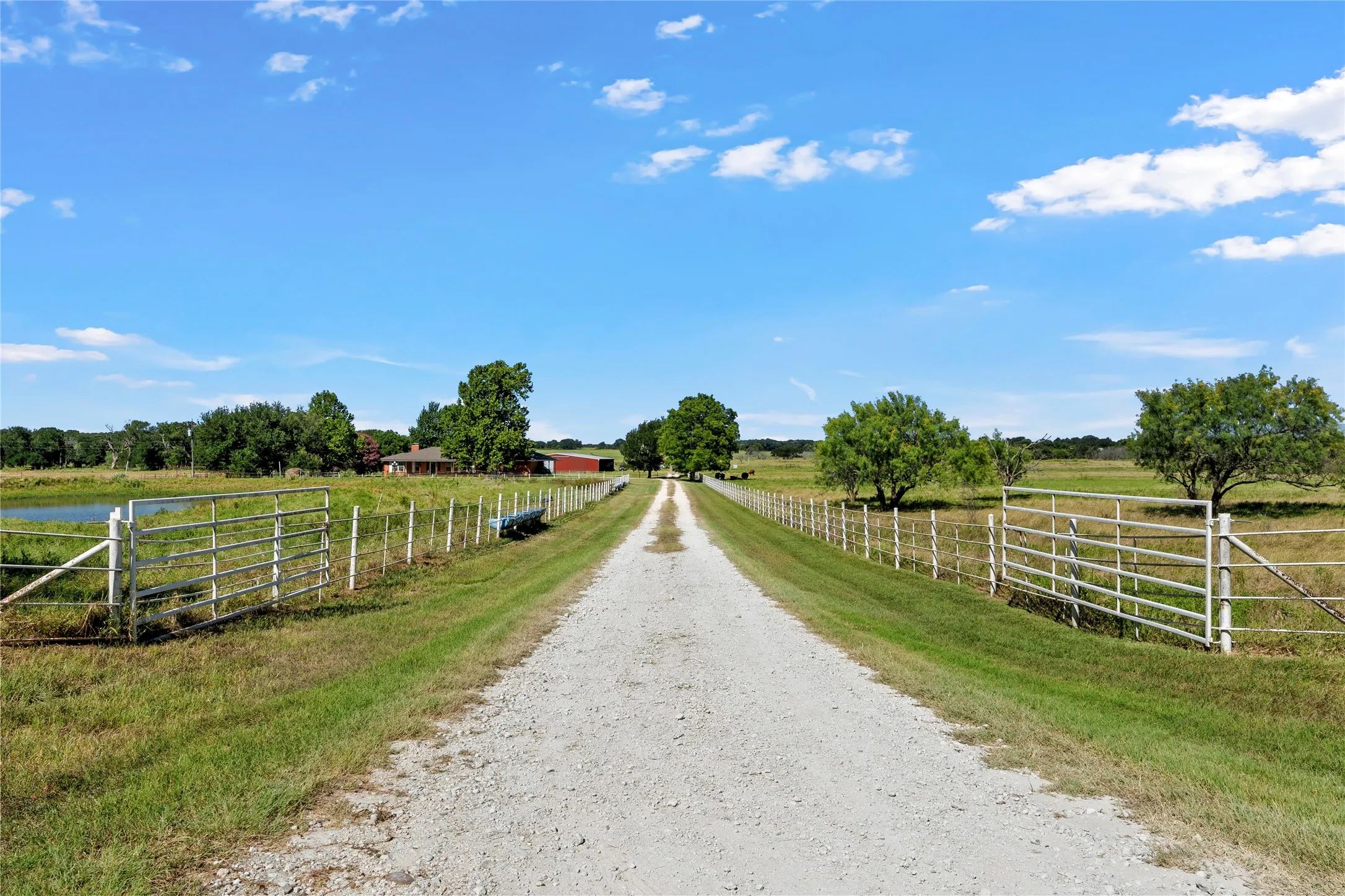 Gravel driveway framed by metal fencing