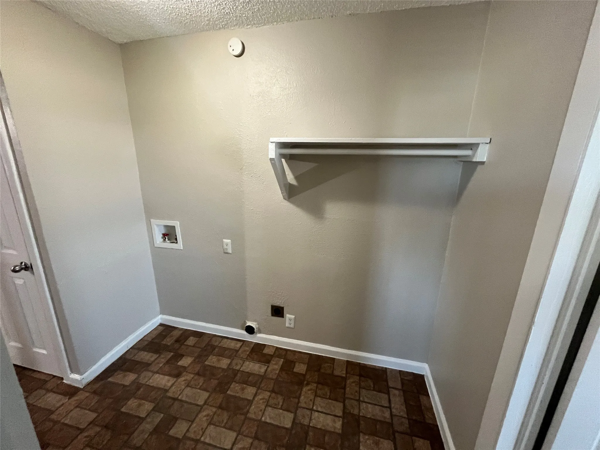 Dedicated laundry area with durable patterned flooring