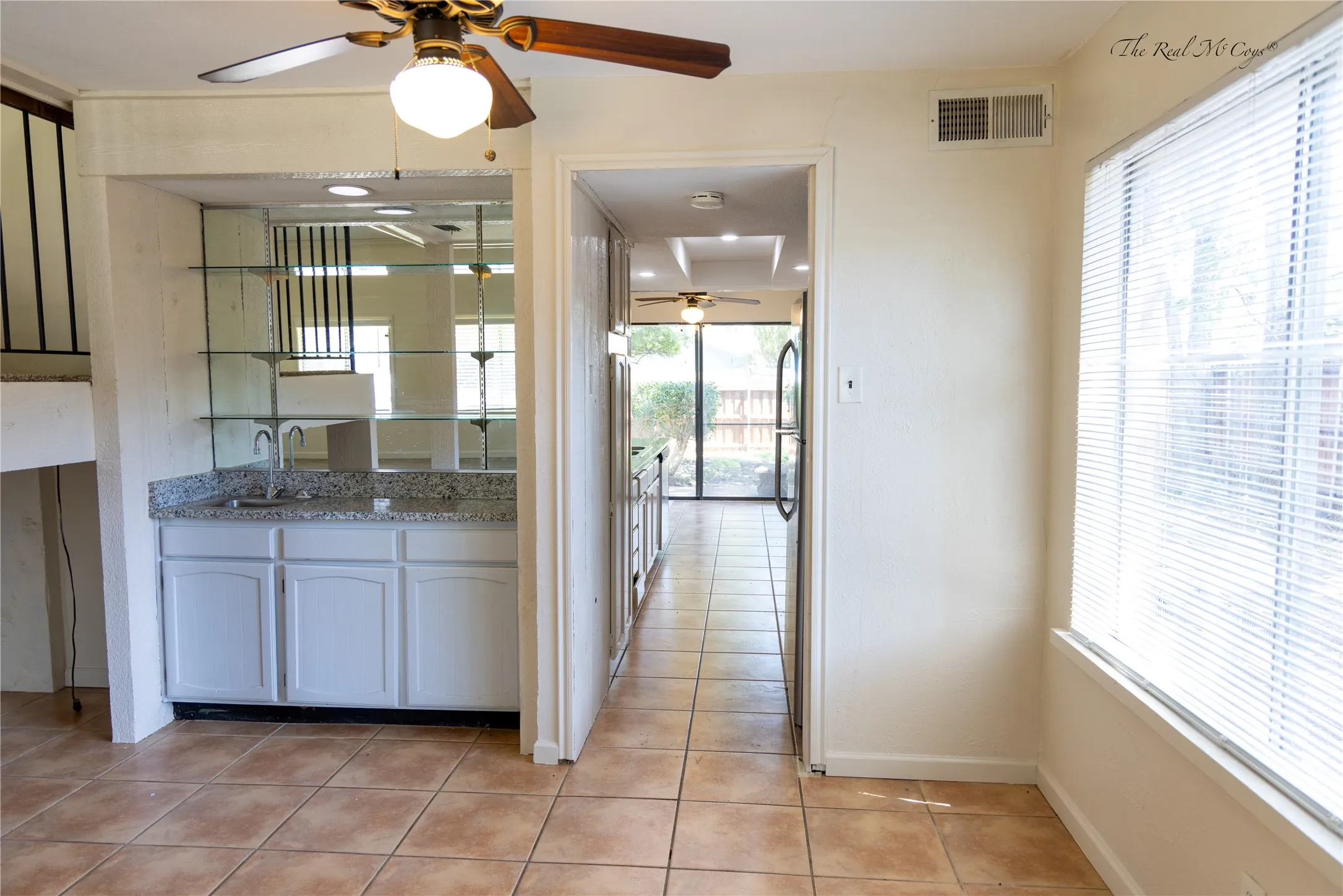 Wet bar in the dining area, with a walk way to the kitchen.