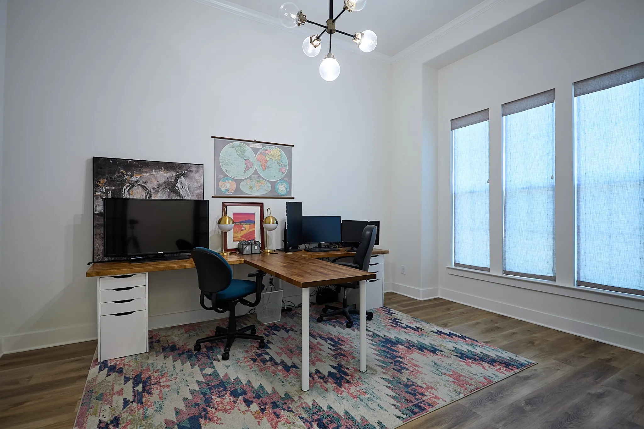 Room featuring neutral wall tones, wood-finish flooring, and crown molding