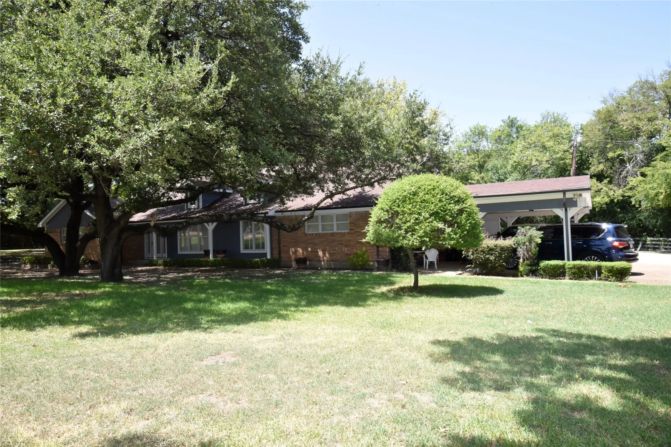 Ranch-style exterior with a partial brick facade and dark siding